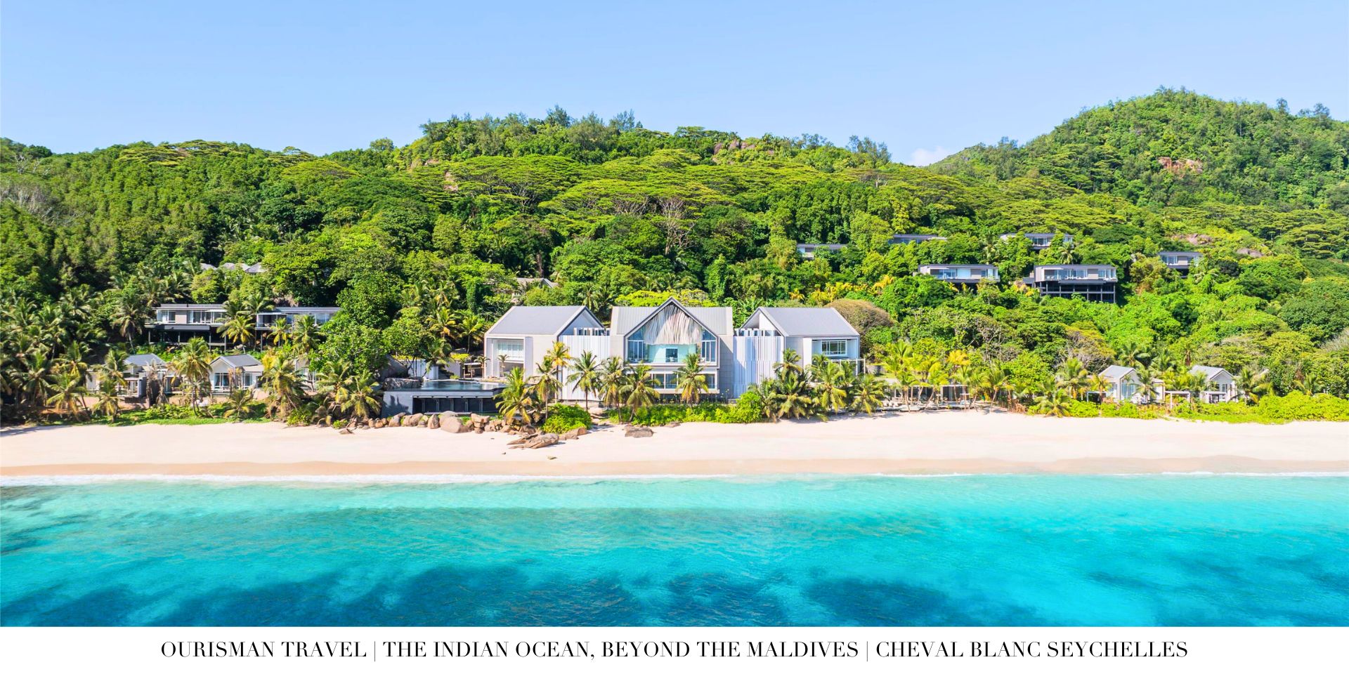 Seychelles luxury resort surrounded by dramatic granite cliffs and turquoise water