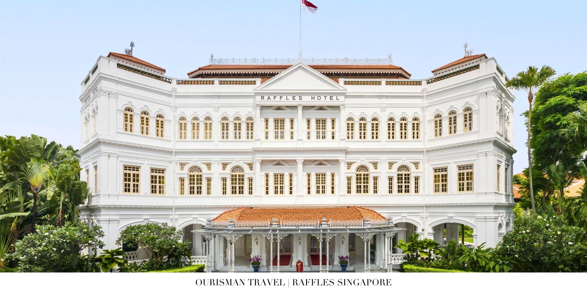 Exterior view of Raffles Singapore’s historic colonial façade with lush tropical landscaping