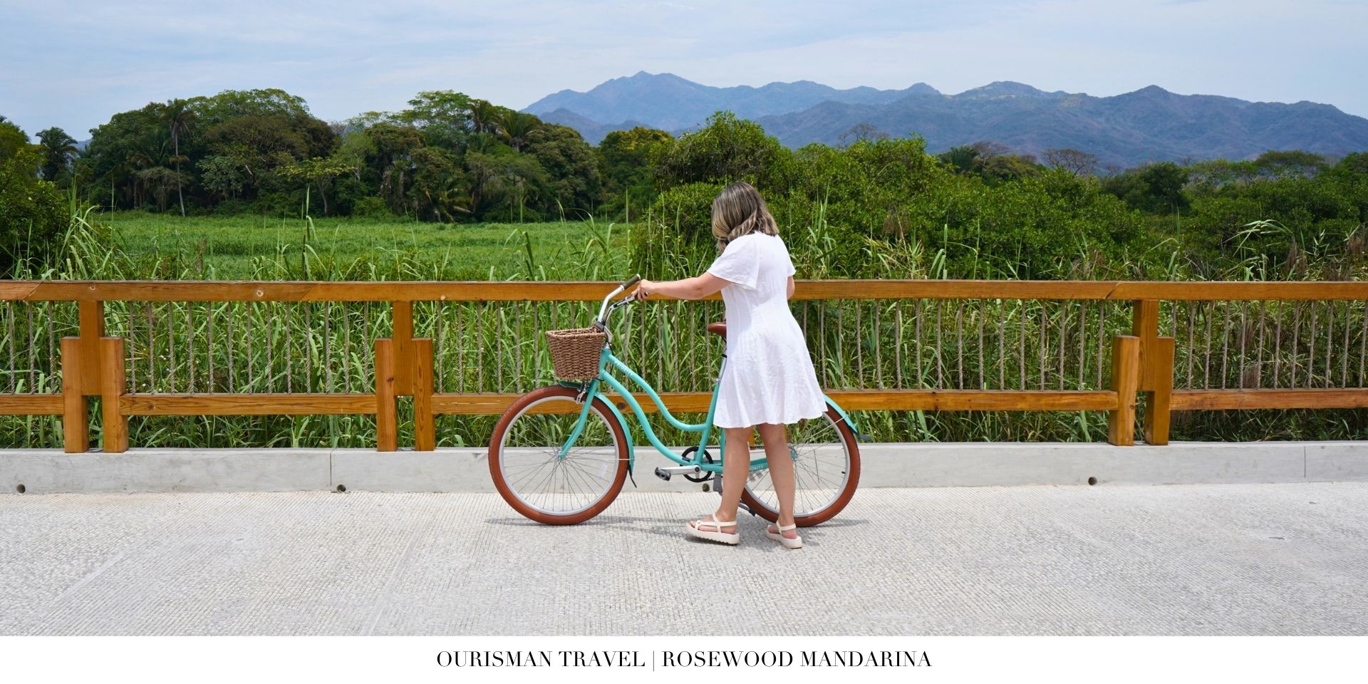 Guests biking through the lush tropical grounds at Rosewood Mandarina surrounded by jungle and coastal scenery