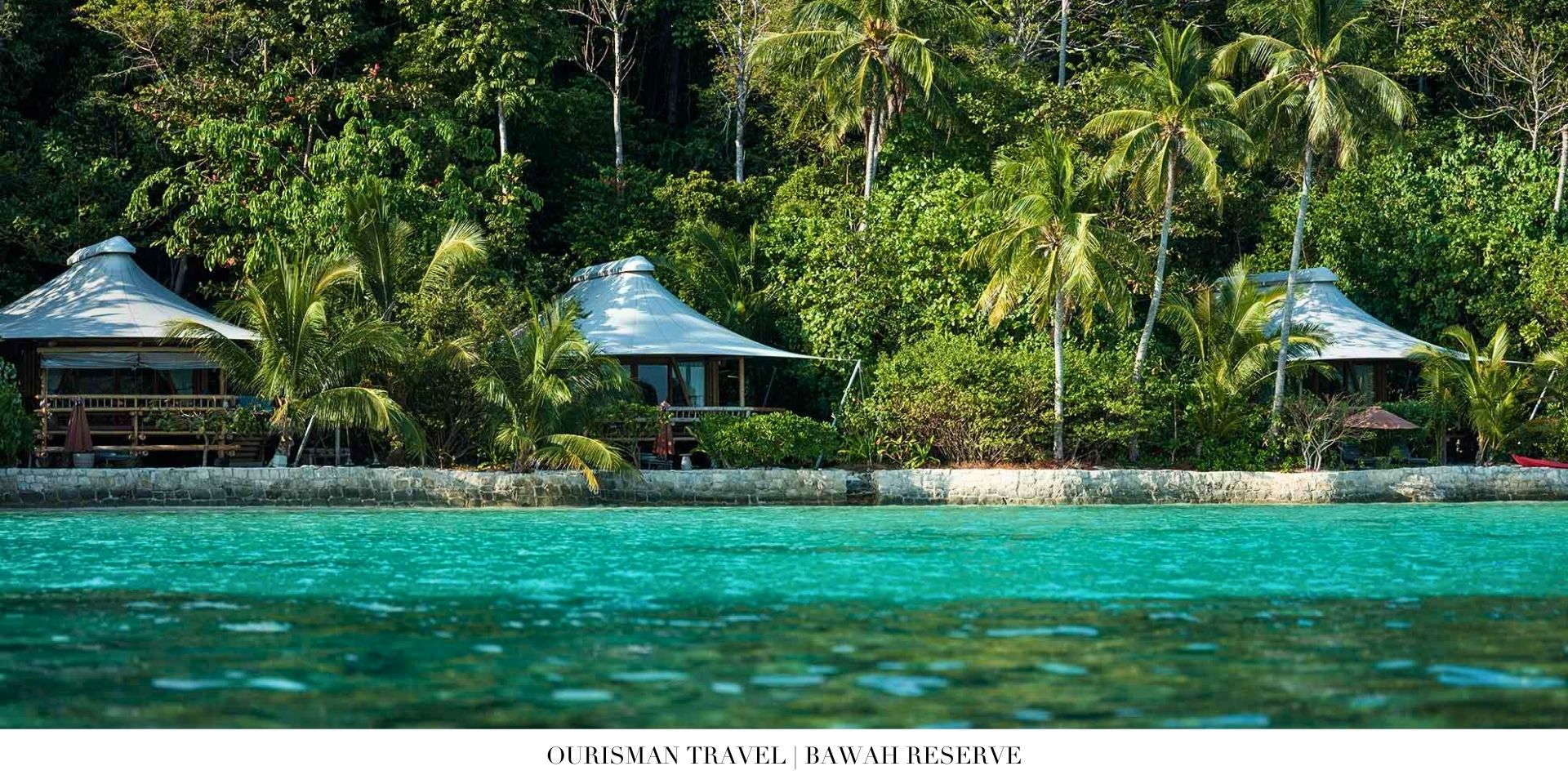 Overwater villa at Bawah Reserve with private deck above turquoise water