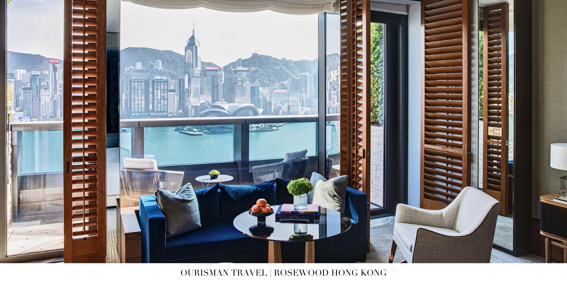 Luxury suite bedroom at Rosewood Hong Kong with floor-to-ceiling windows and city views