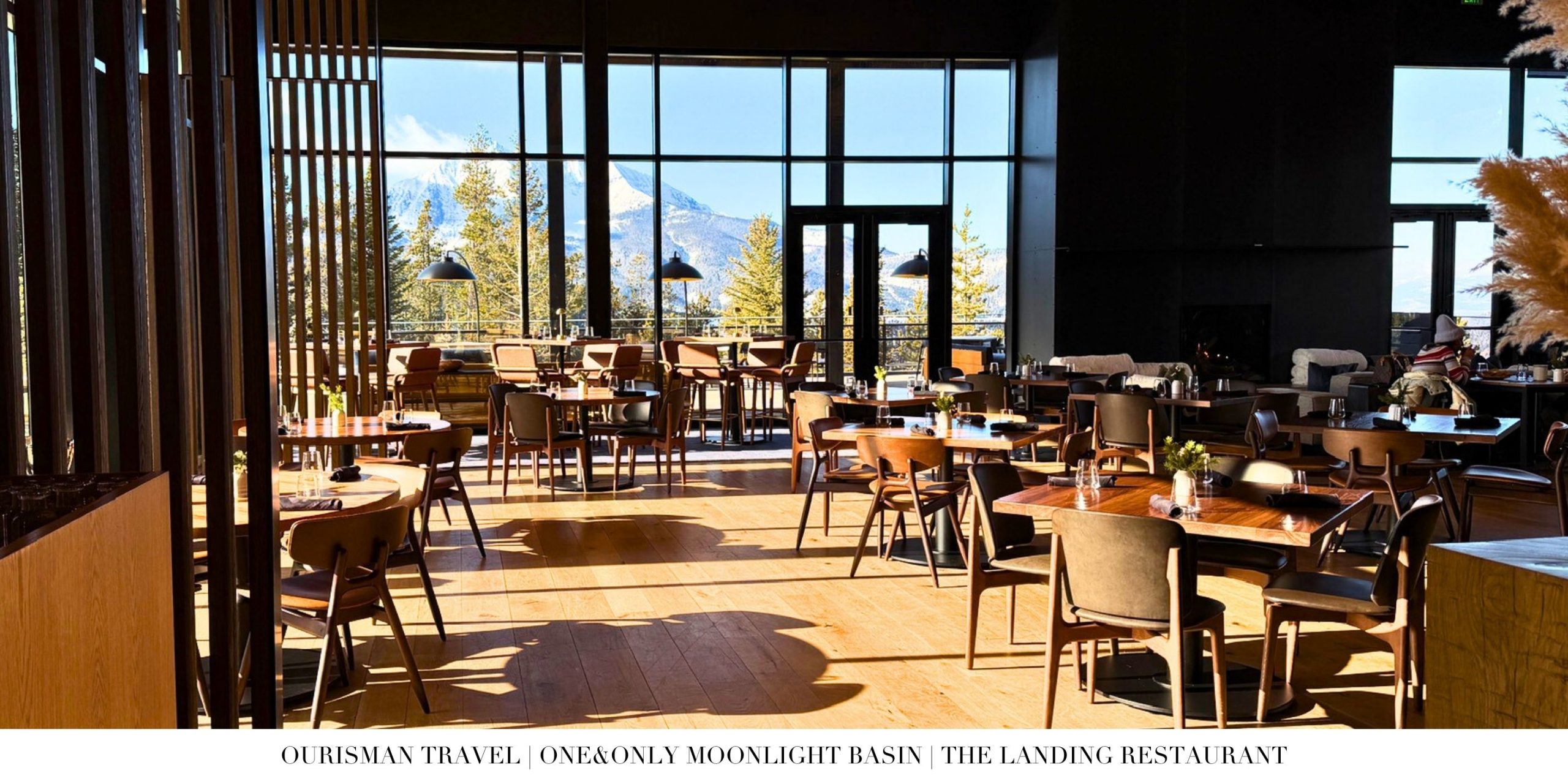 Dining room at The Landing at One&Only Moonlight Basin with floor-to-ceiling windows overlooking Lone Peak.