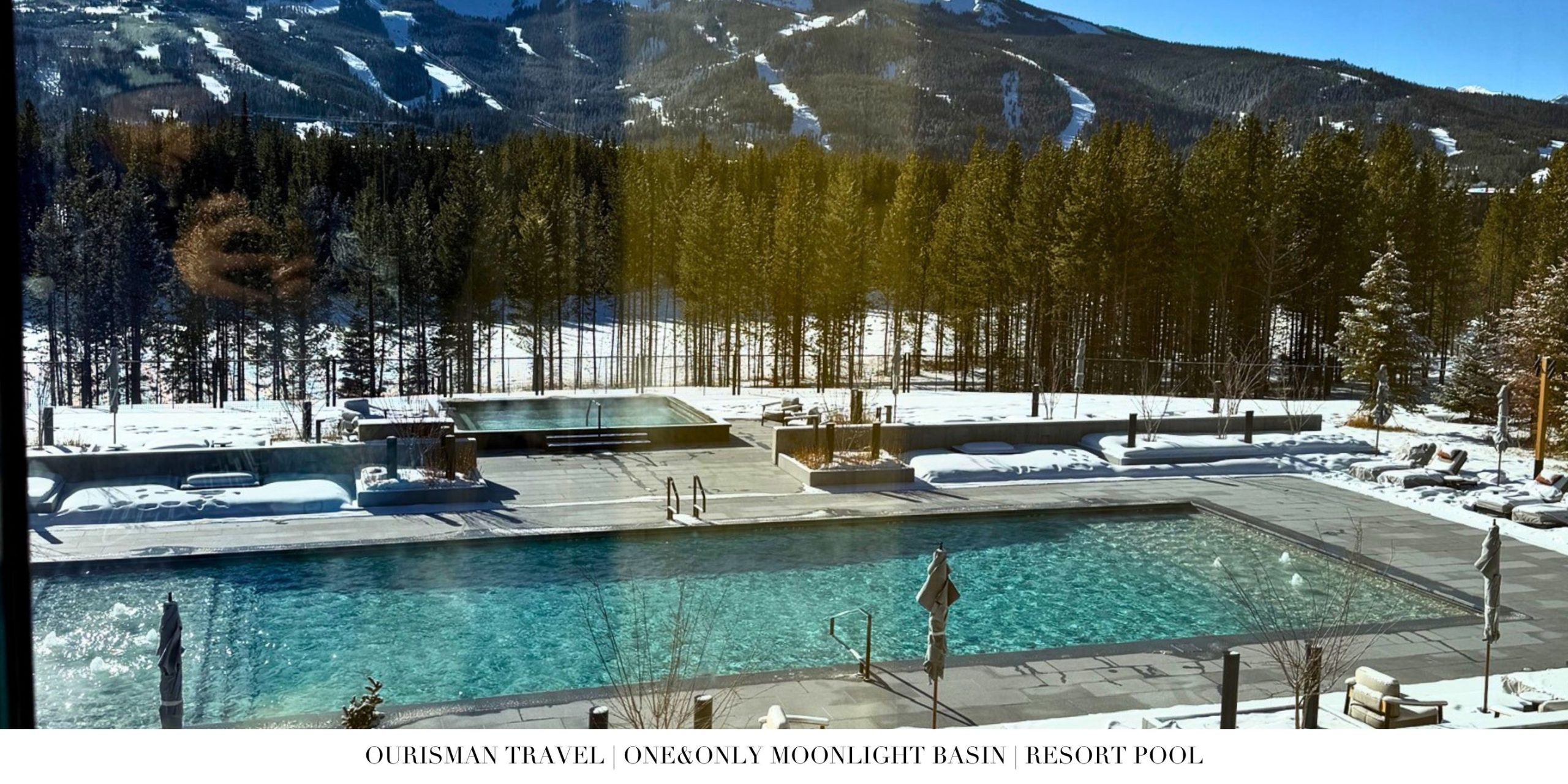 Heated outdoor resort pool at One&Only Moonlight Basin surrounded by snow-covered mountains, offering a warm soak in Big Sky’s winter setting.