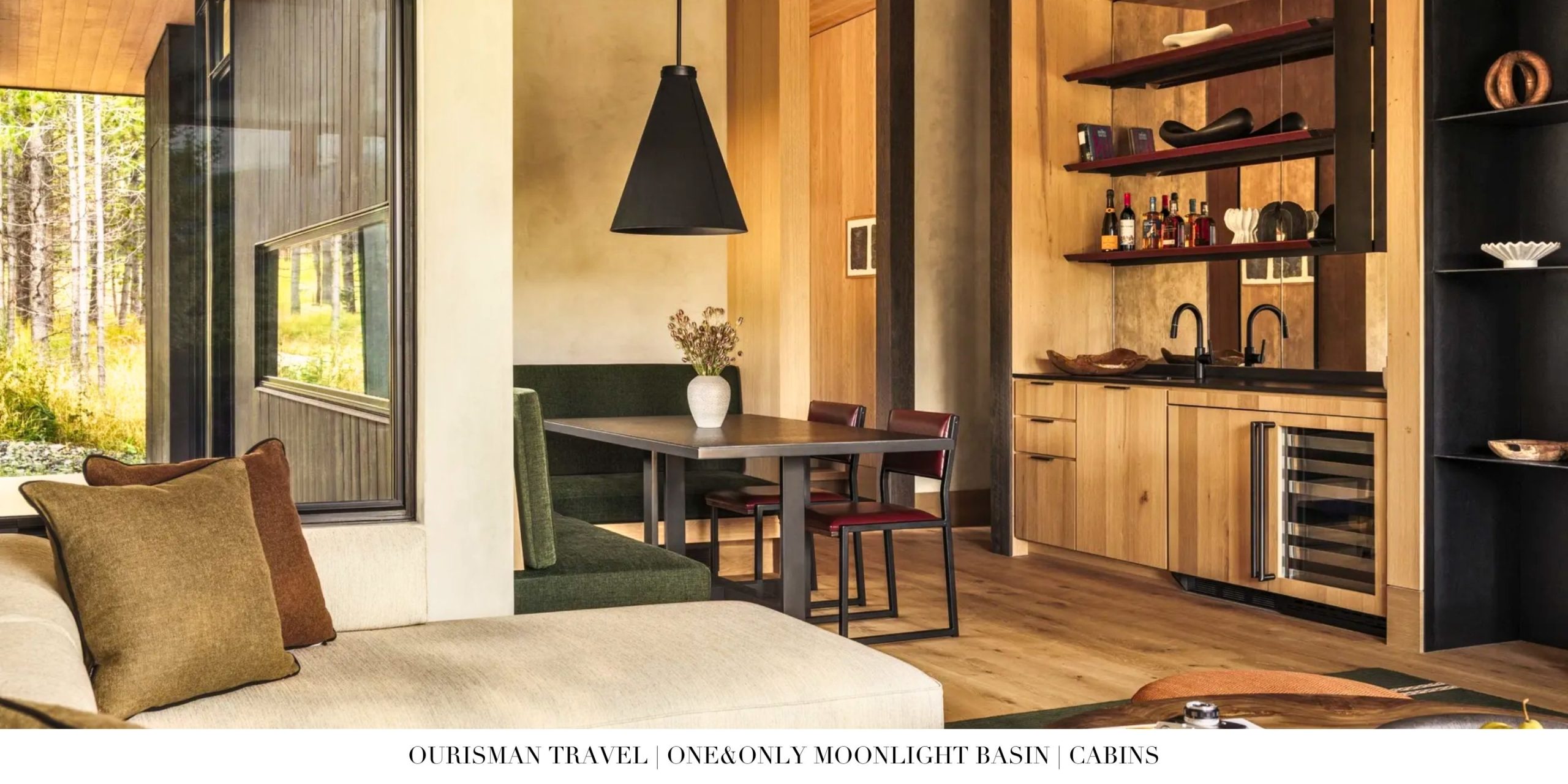 Dining area inside a private cabin at One&Only Moonlight Basin featuring a spacious table, warm wood finishes, and expansive windows overlooking the Montana mountain landscape.
