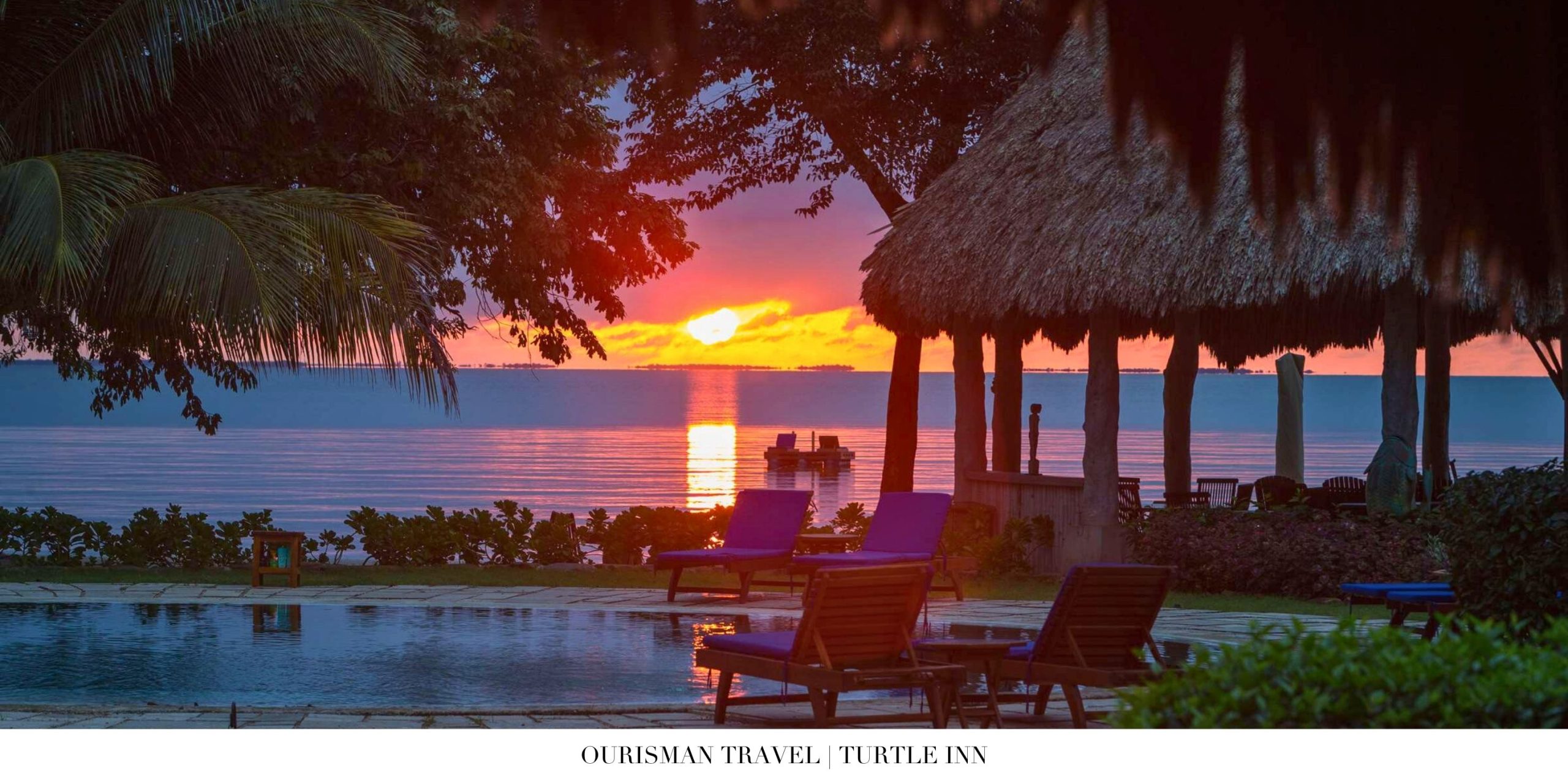 Night view of Turtle Inn overwater cabanas reflecting on the lagoon