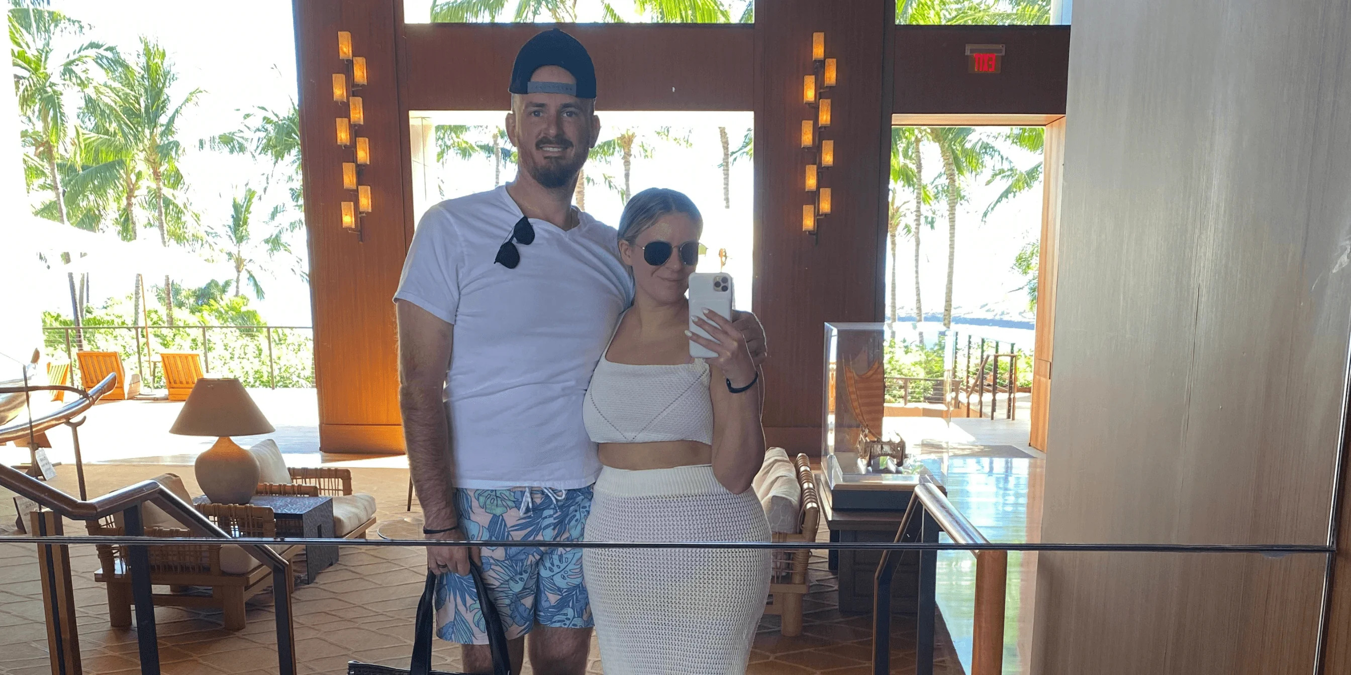 Couple mirror selfie in hotel lobby with ocean view