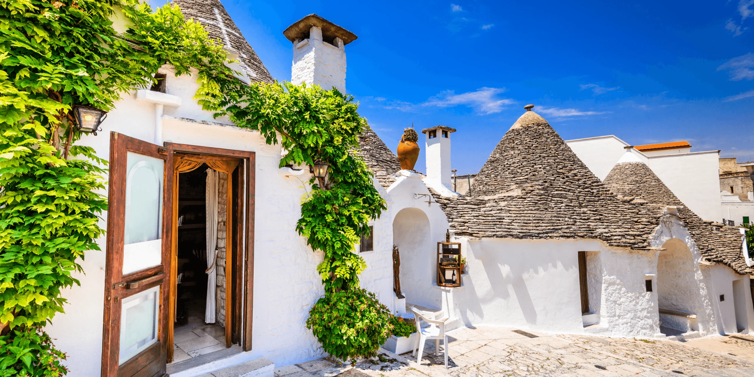 Trulli houses in Puglia Italy with white walls and stone roofs