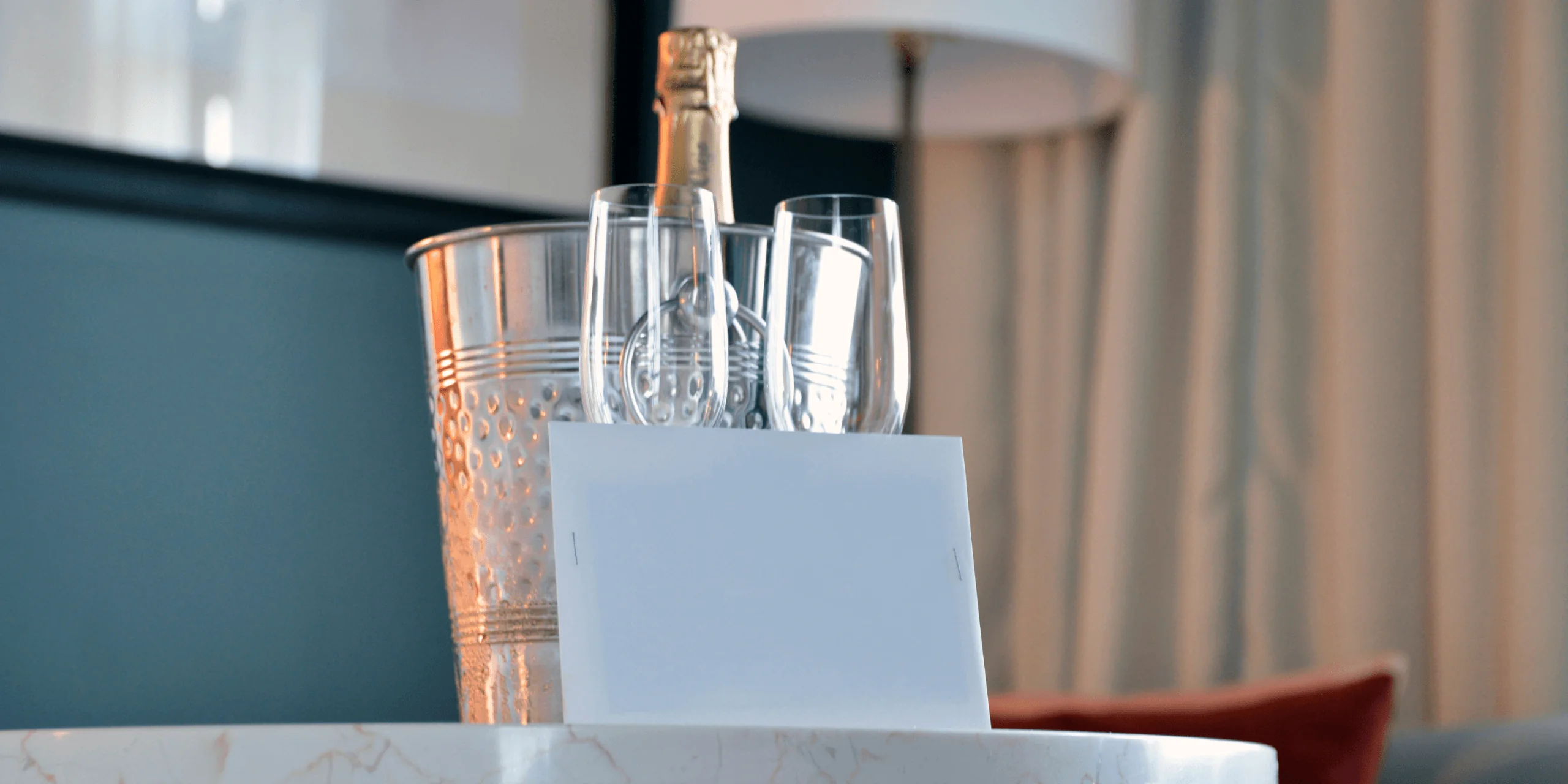 Champagne bottle with glasses and welcome card