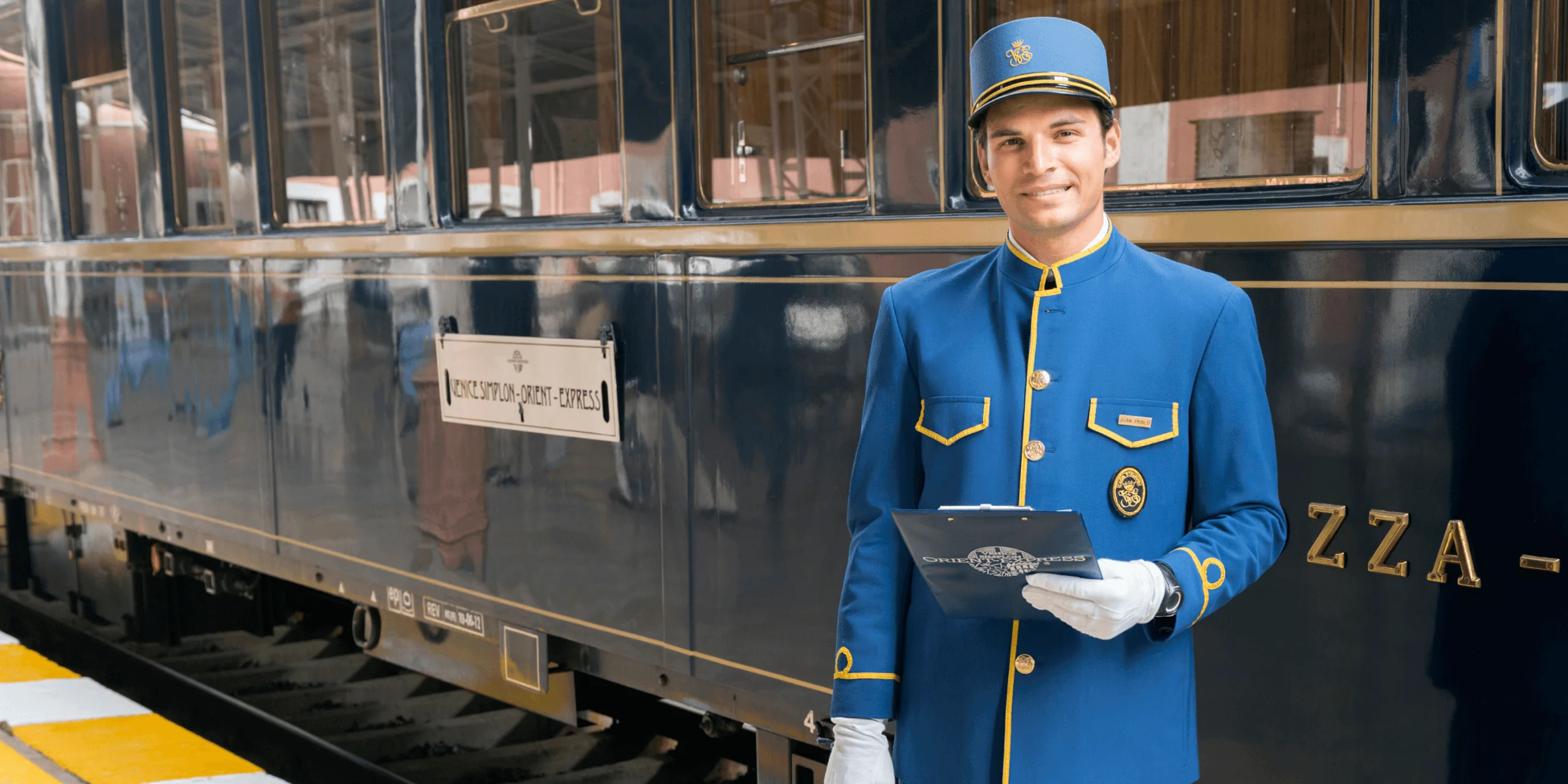 Train conductor standing beside luxury train
