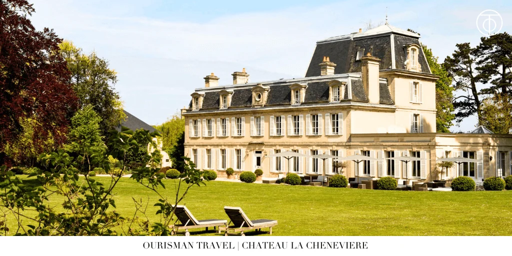 Garden lawn and historic exterior of Chateau La Cheneviere in Normandy