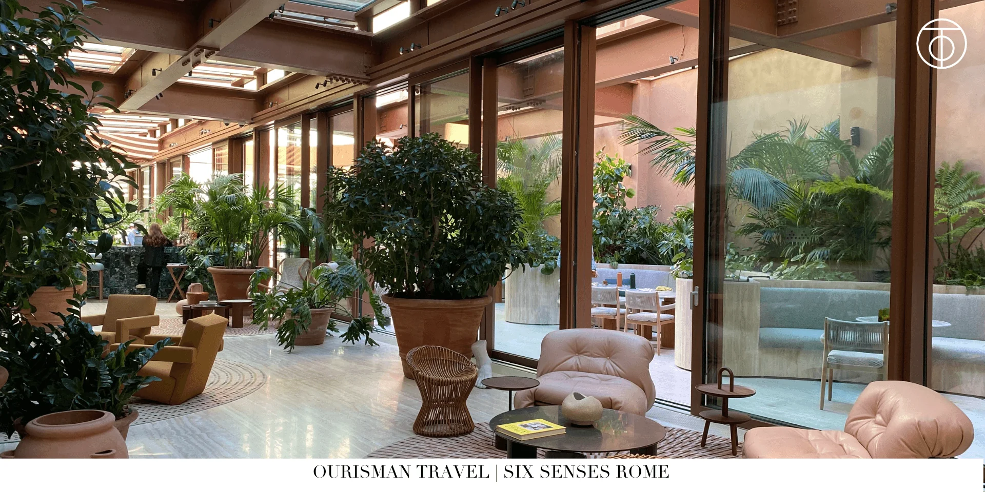 Indoor courtyard lounge at Six Senses Rome with greenery and relaxed seating