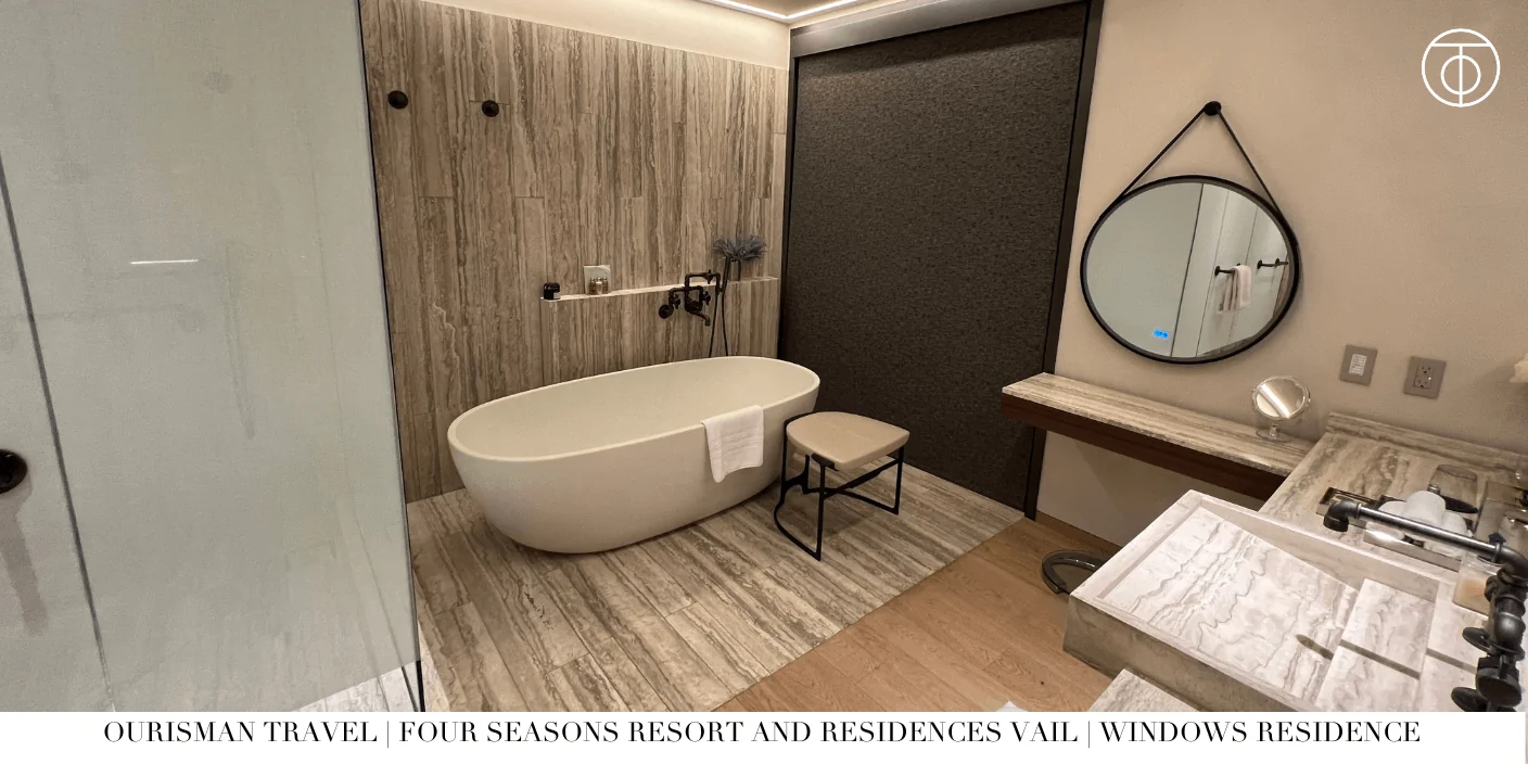 Marble bathroom with soaking tub at Windows Residence