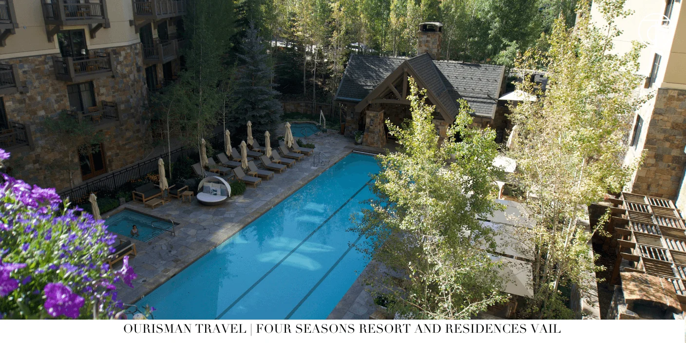 Heated outdoor pool at Four Seasons Vail surrounded by snowy mountains
