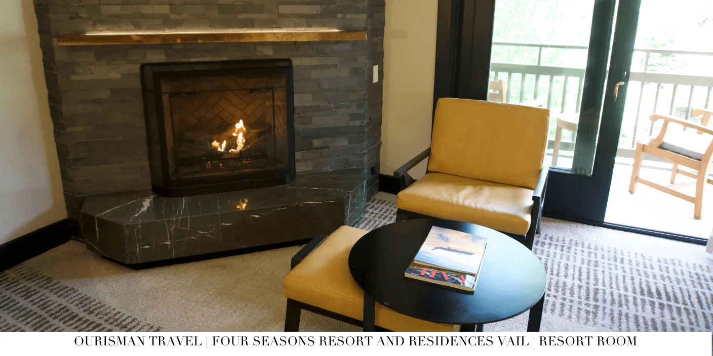 Four Seasons Vail suite living area with stone fireplace