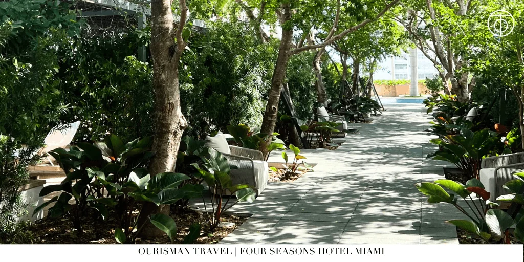 Garden walkway at Four Seasons Hotel Miami surrounded by tropical landscaping.