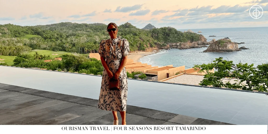 Guest standing by an infinity pool overlooking the coastline at Four Seasons Resort Tamarindo in Mexico