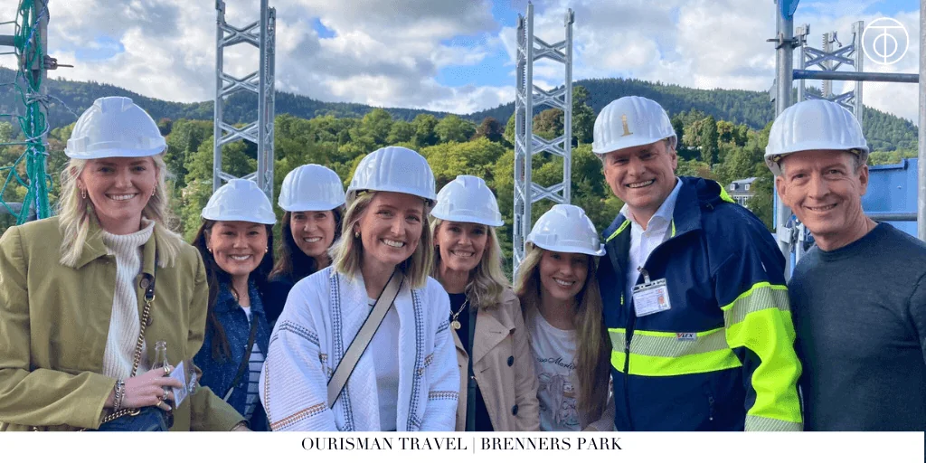 Group of visitors wearing hard hats during a construction site tour