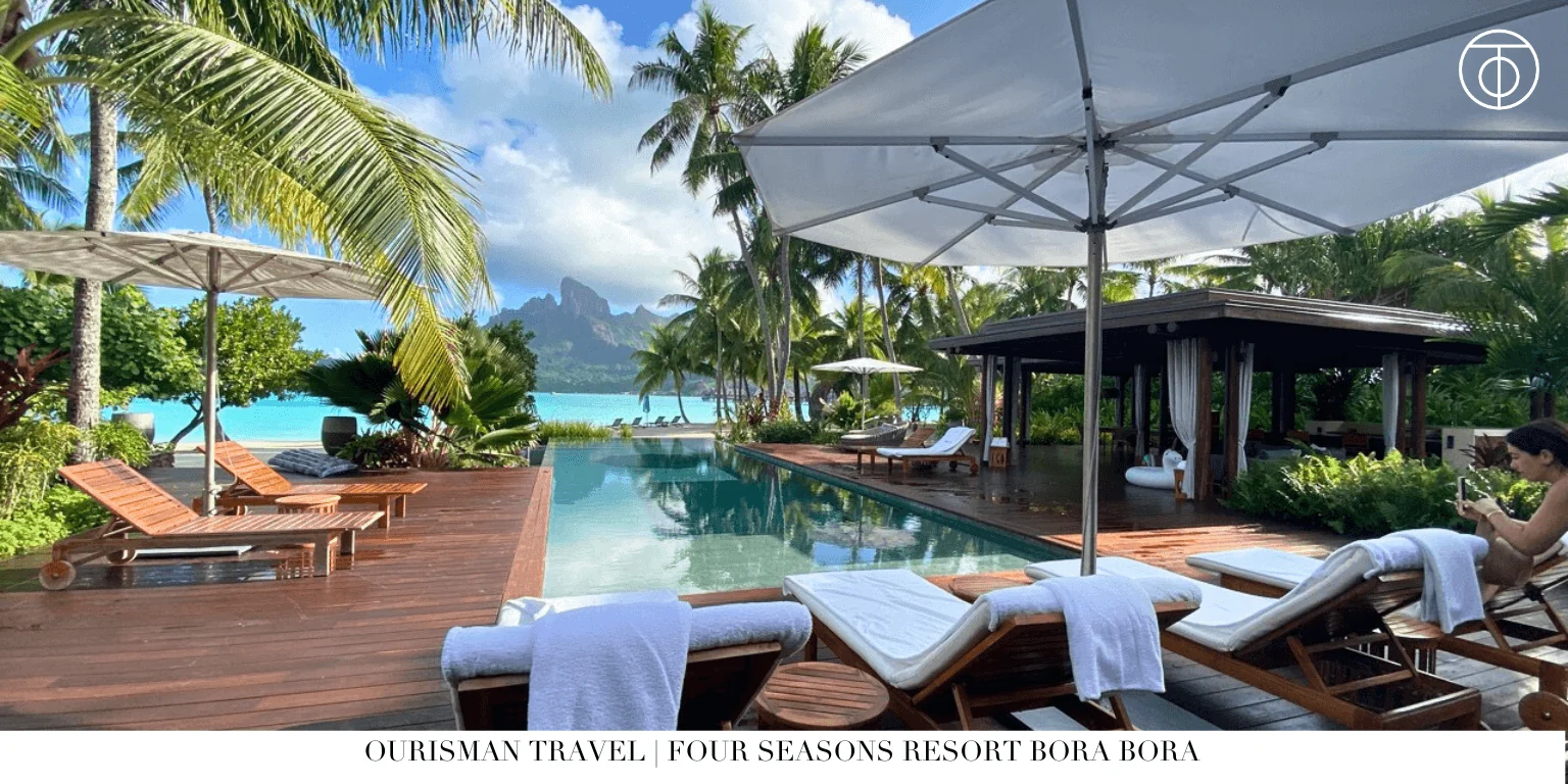 Four Seasons Bora Bora pool with lounge chairs and ocean view