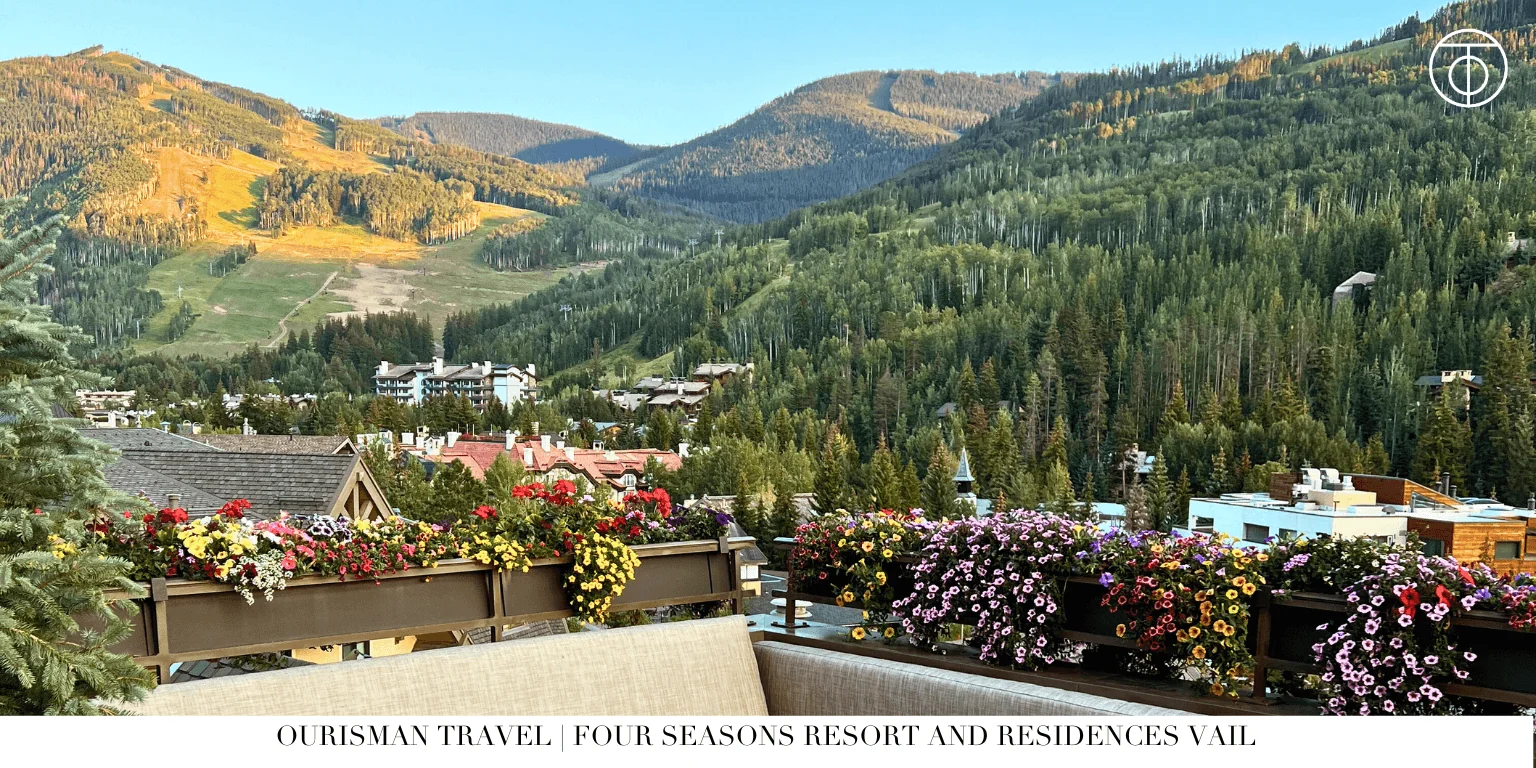 Mountain view from resort terrace with flowers and hills