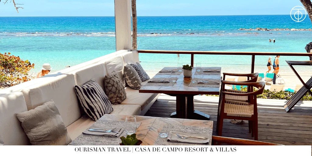 Outdoor restaurant terrace overlooking turquoise ocean at Casa de Campo Resort and Villas