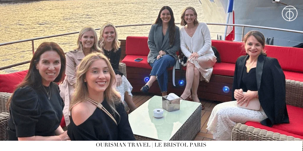 Group of travelers seated on a boat during a sunset cruise on the Seine River in Paris