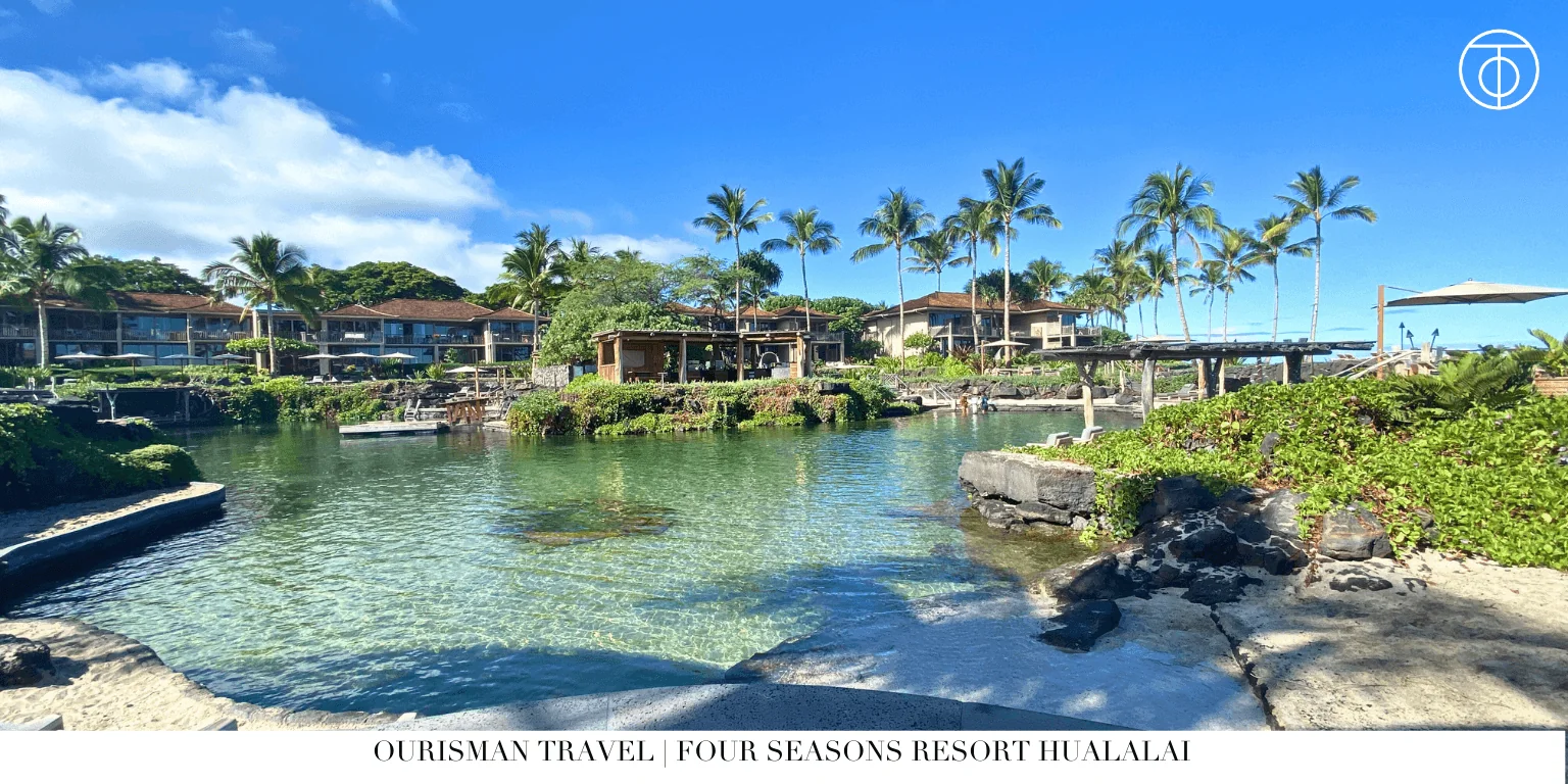 Four Seasons Hualalai lagoon pool with palm trees Hawaii