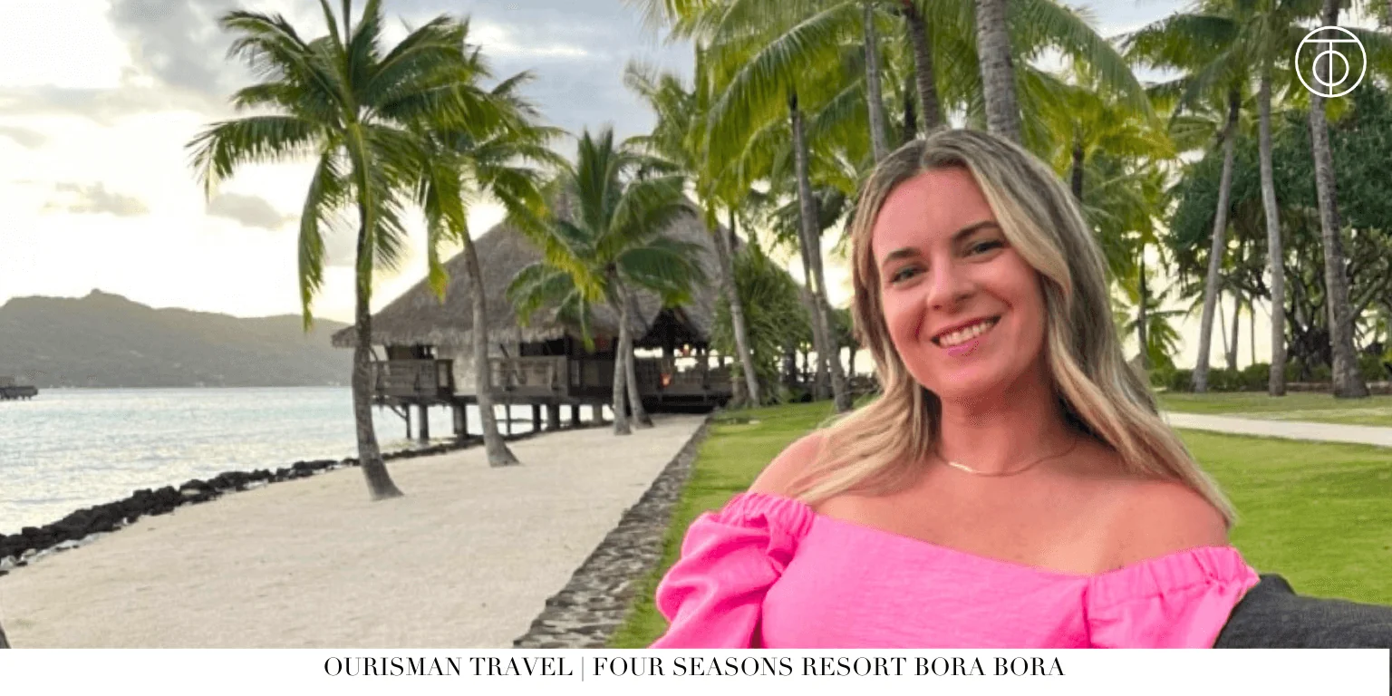 Guest at Four Seasons Bora Bora with palm trees and beach