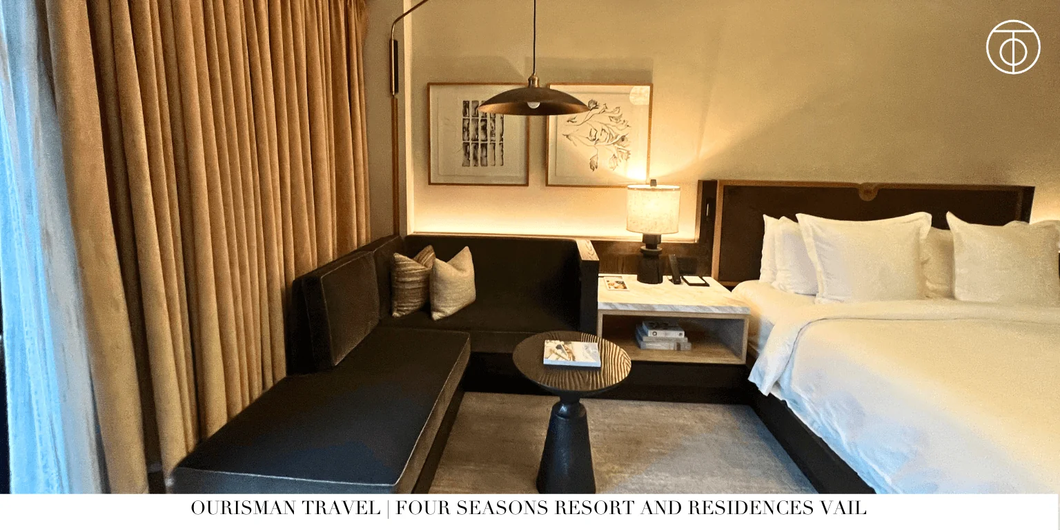 Luxury hotel room with seating area and warm lighting