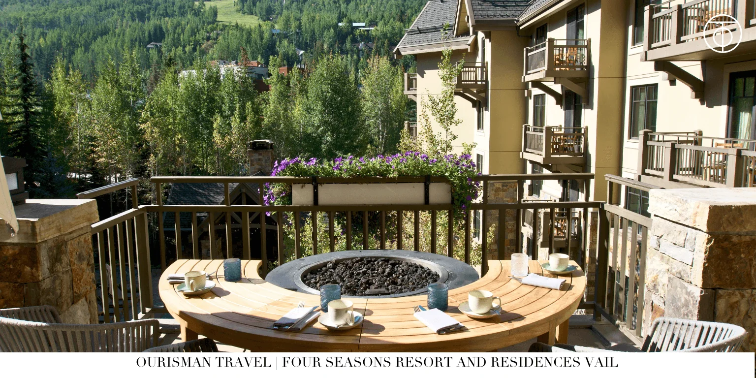 Mountain resort balcony with fire pit and forest view