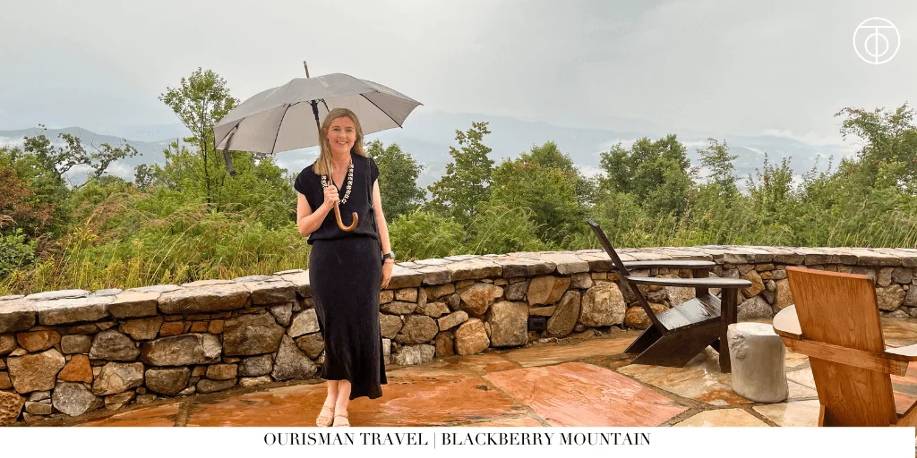 Guest standing on a stone terrace overlooking the Smoky Mountains at Blackberry Mountain in Tennessee
