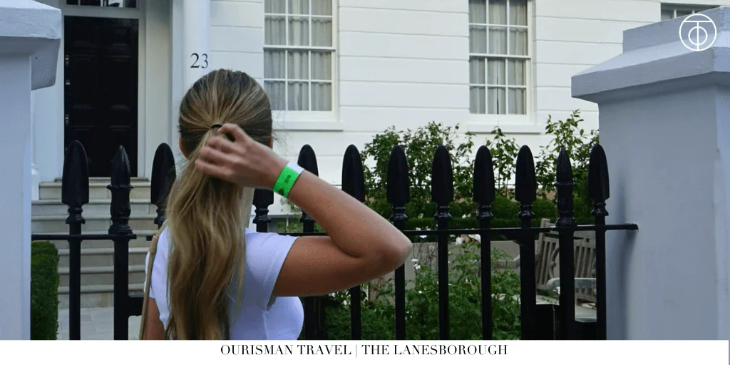 Guest standing outside a white townhouse building near Hyde Park in London