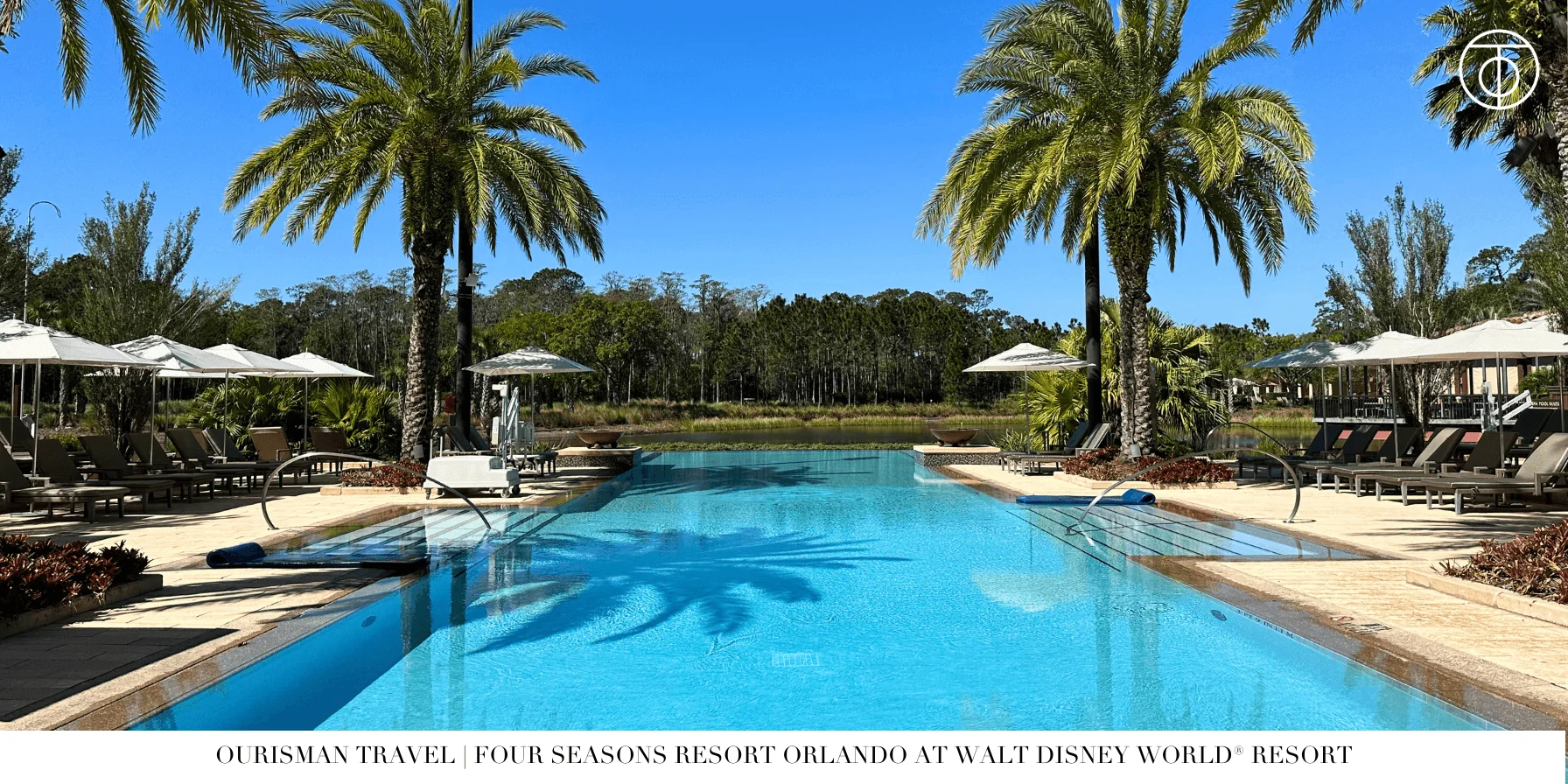Resort pool with palm trees at Four Seasons Orlando