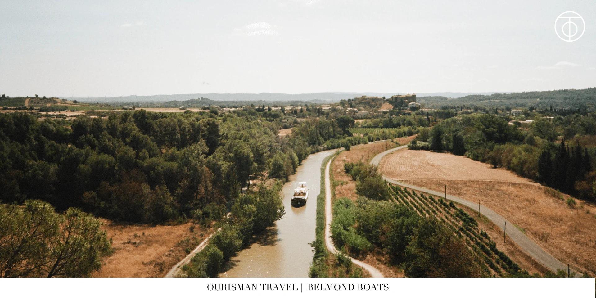 Belmond luxury barge cruising along a canal in the French countryside