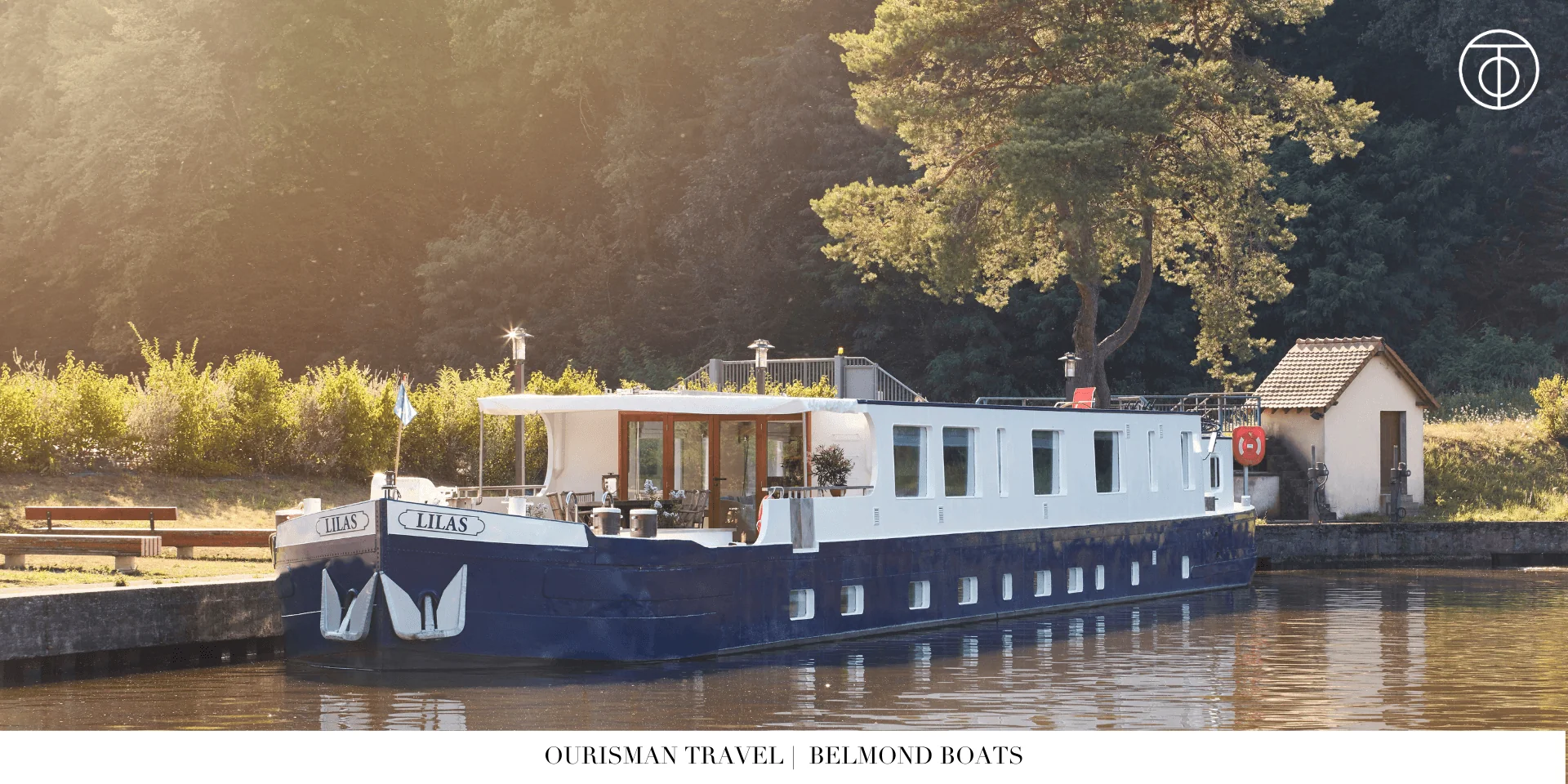 Belmond luxury barge sailing along a narrow canal in France
