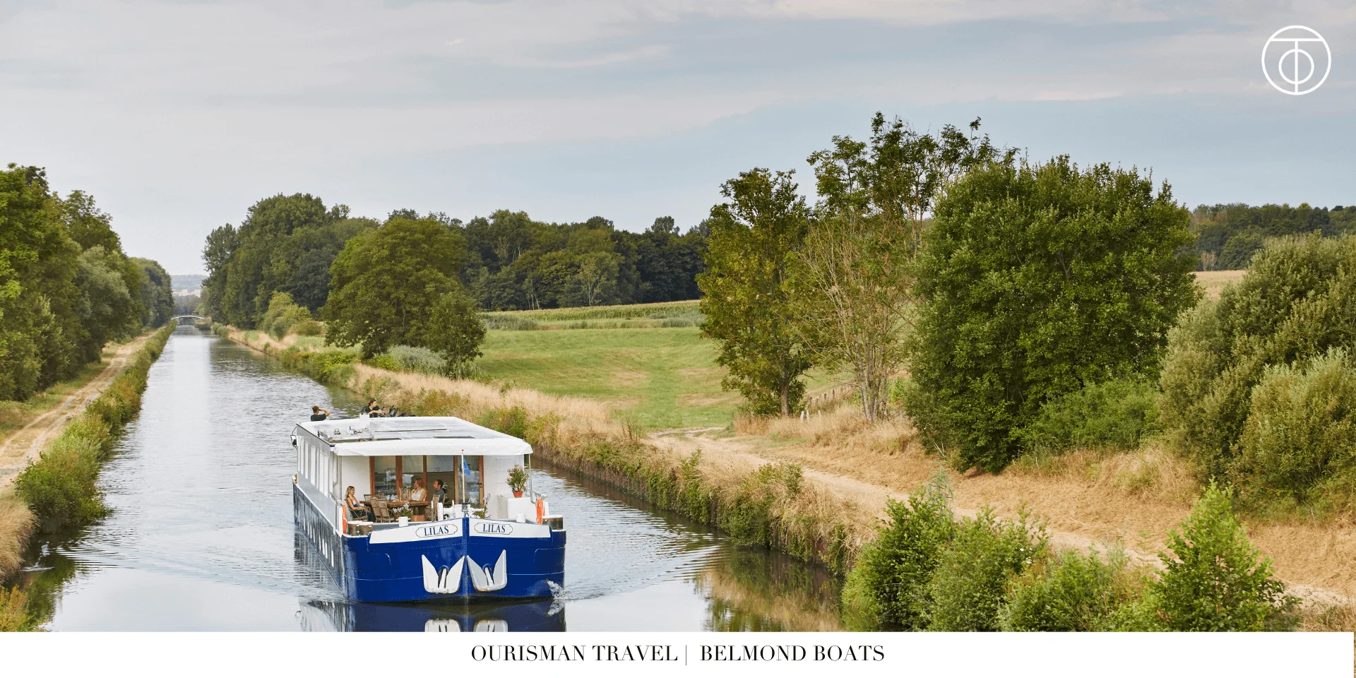 Small barge cruising through a canal