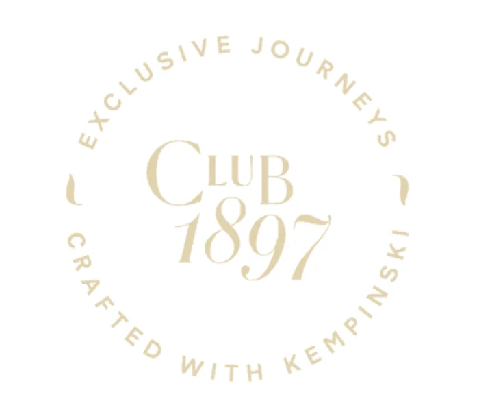 Club 1897 by Kempinski logo highlighting top Kempinski travel agency Ourisman Travel, offering VIP amenities, daily breakfast, room upgrades, and exclusive preferred partner benefits at Kempinski Hotels worldwide