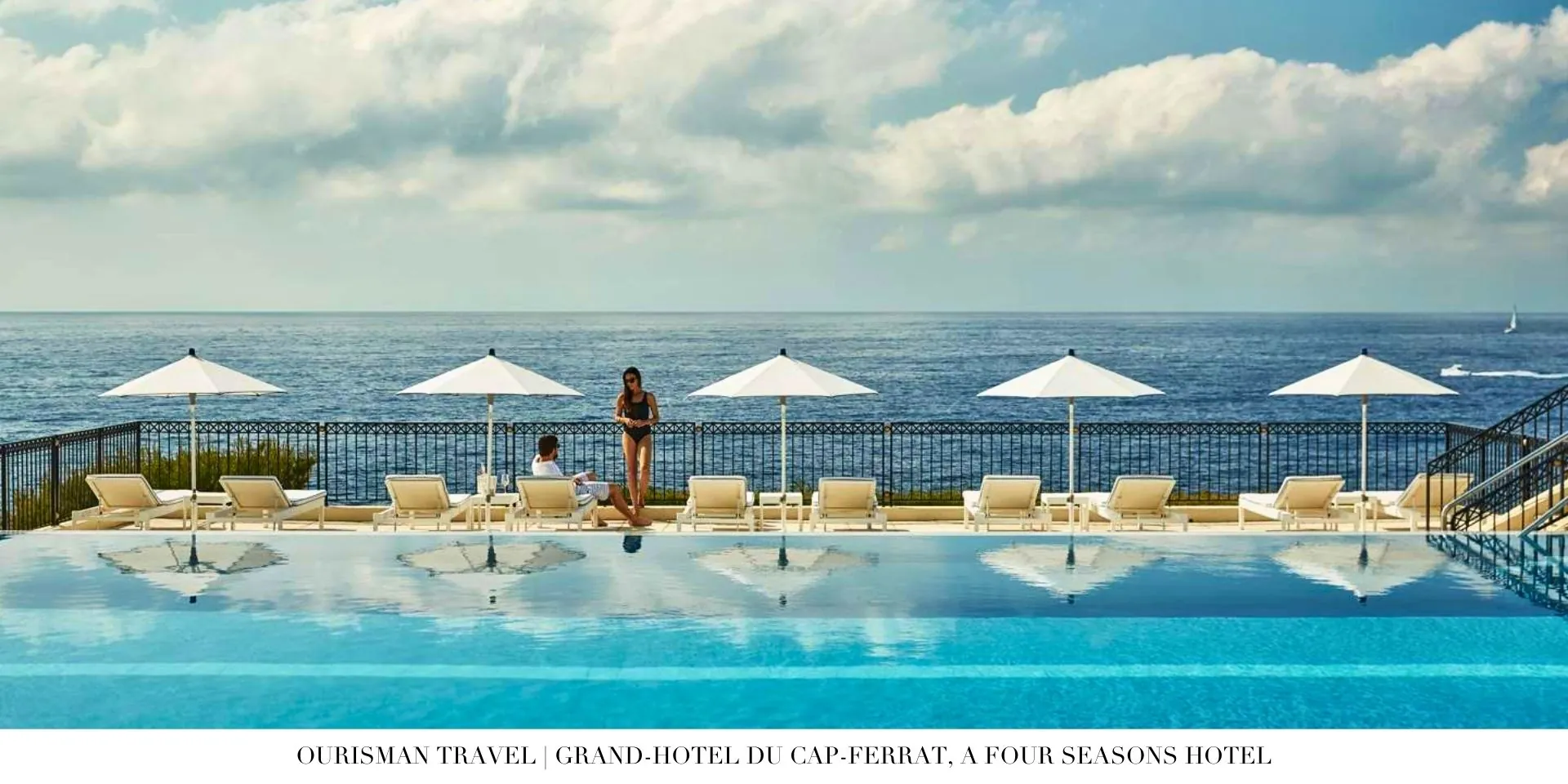 Evening view of Grand-Hôtel du Cap-Ferrat illuminated with warm lights against the sea