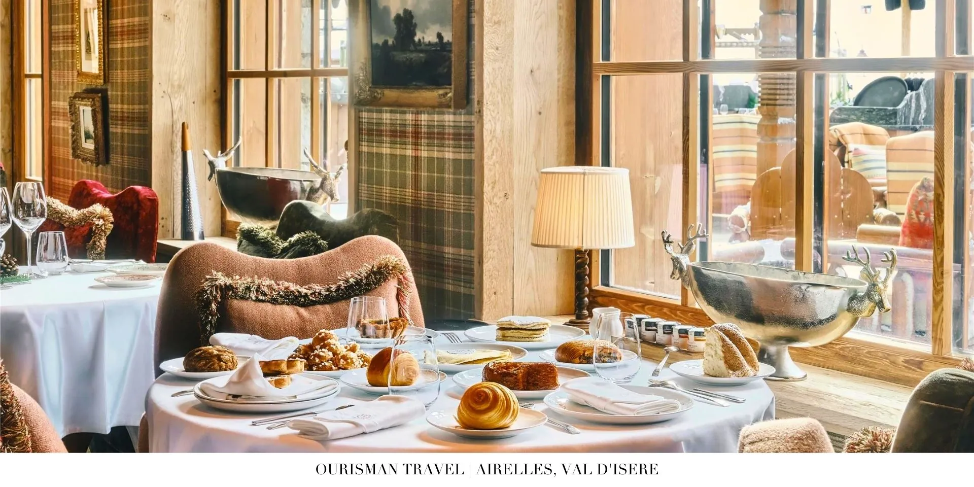 Alpine-inspired dining room at Airelles, Val d’Isère with warm wooden accents and panoramic views