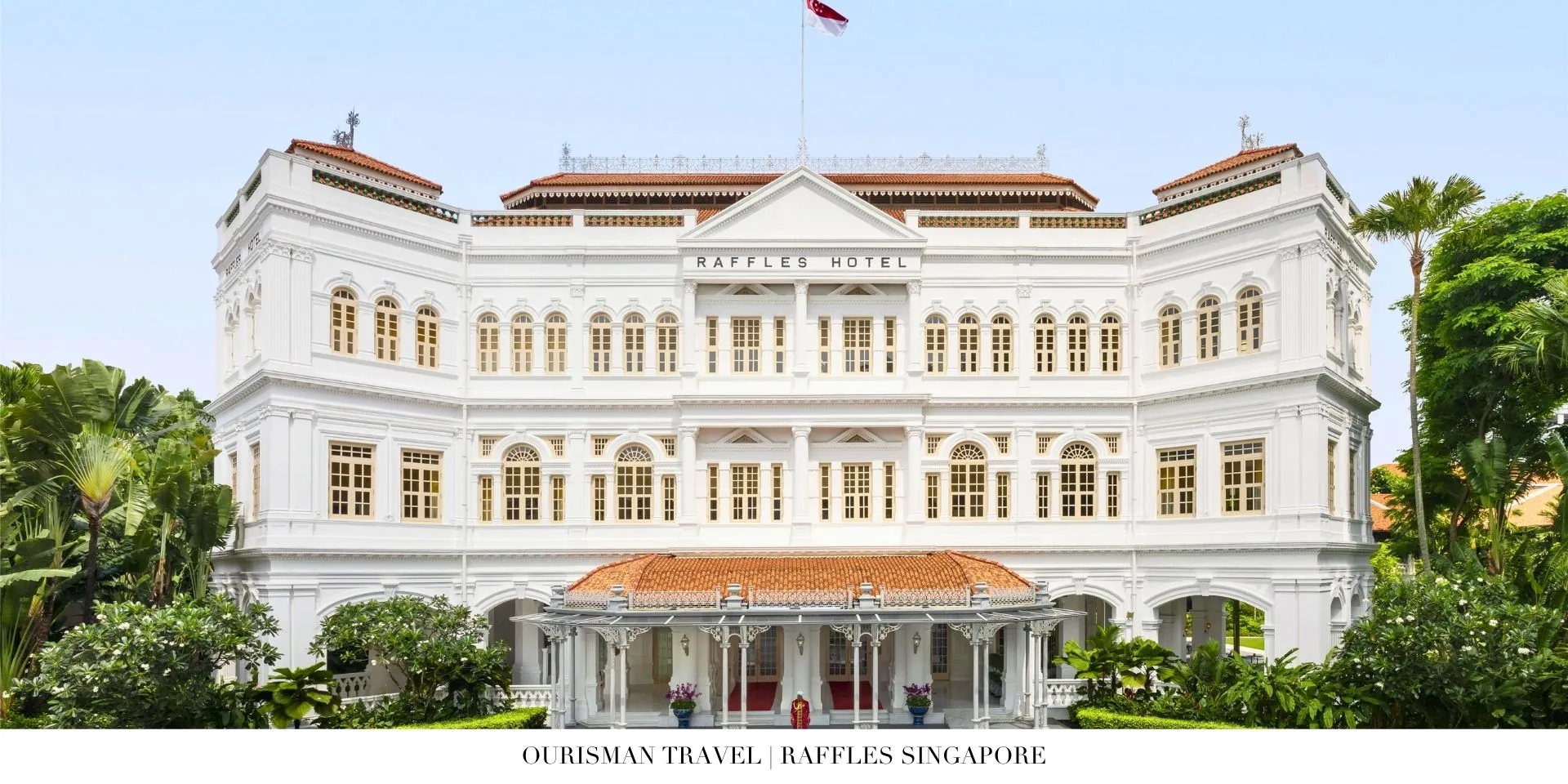Exterior view of Raffles Singapore’s historic colonial façade with lush tropical landscaping