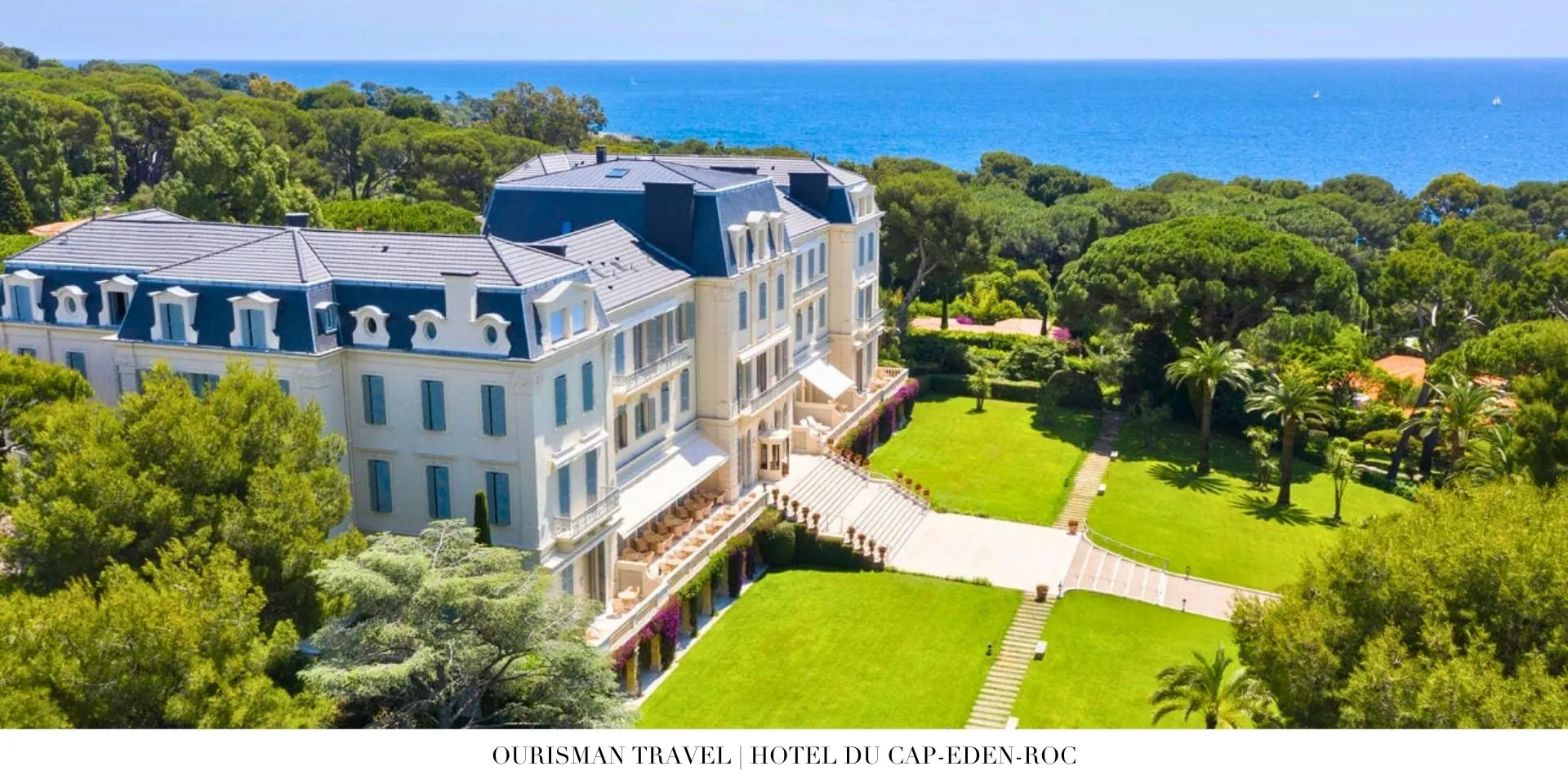 Panoramic exterior view of Hotel du Cap-Eden-Roc with lush gardens and sparkling coastline