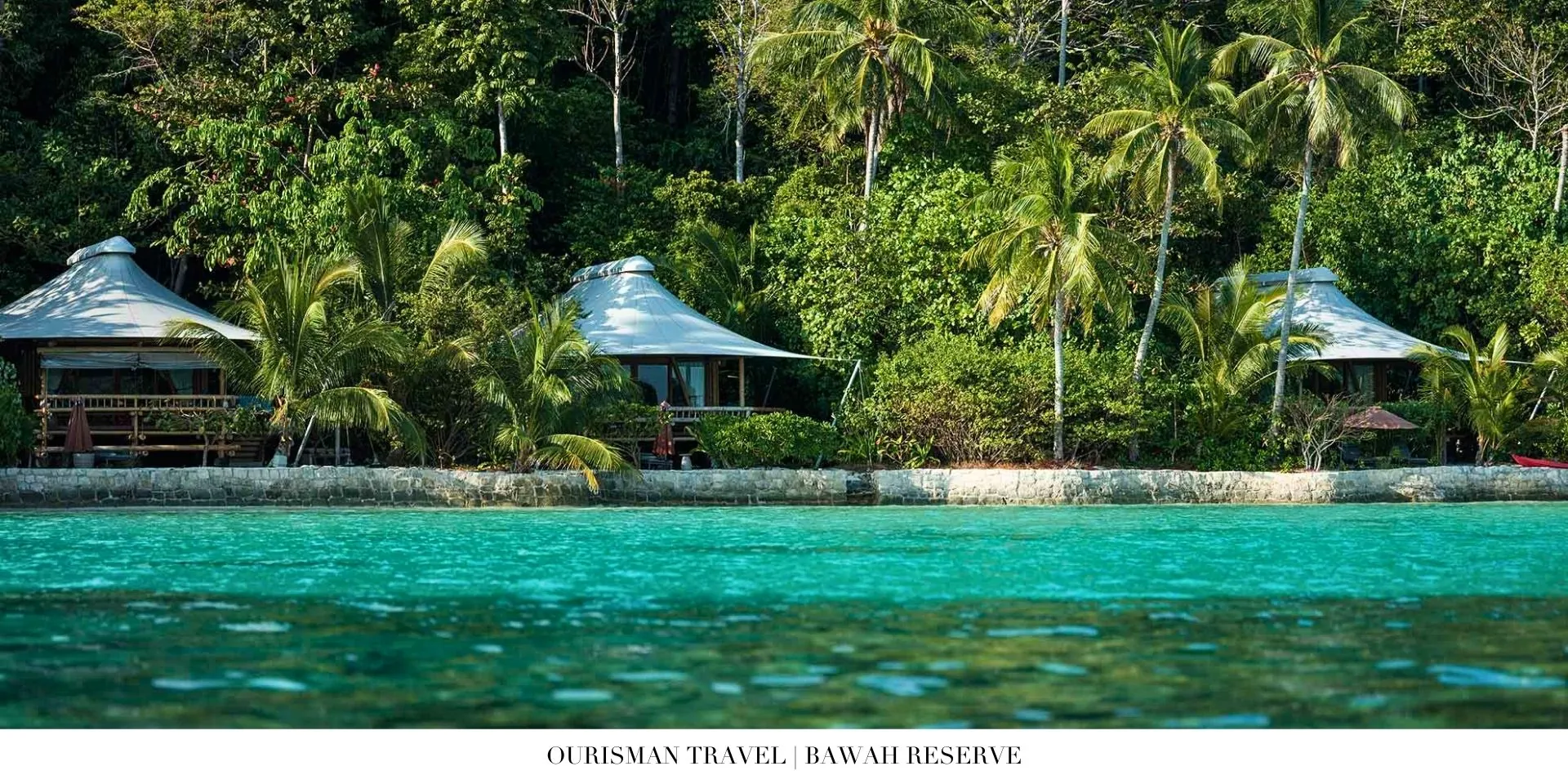 Overwater villa at Bawah Reserve with private deck above turquoise water