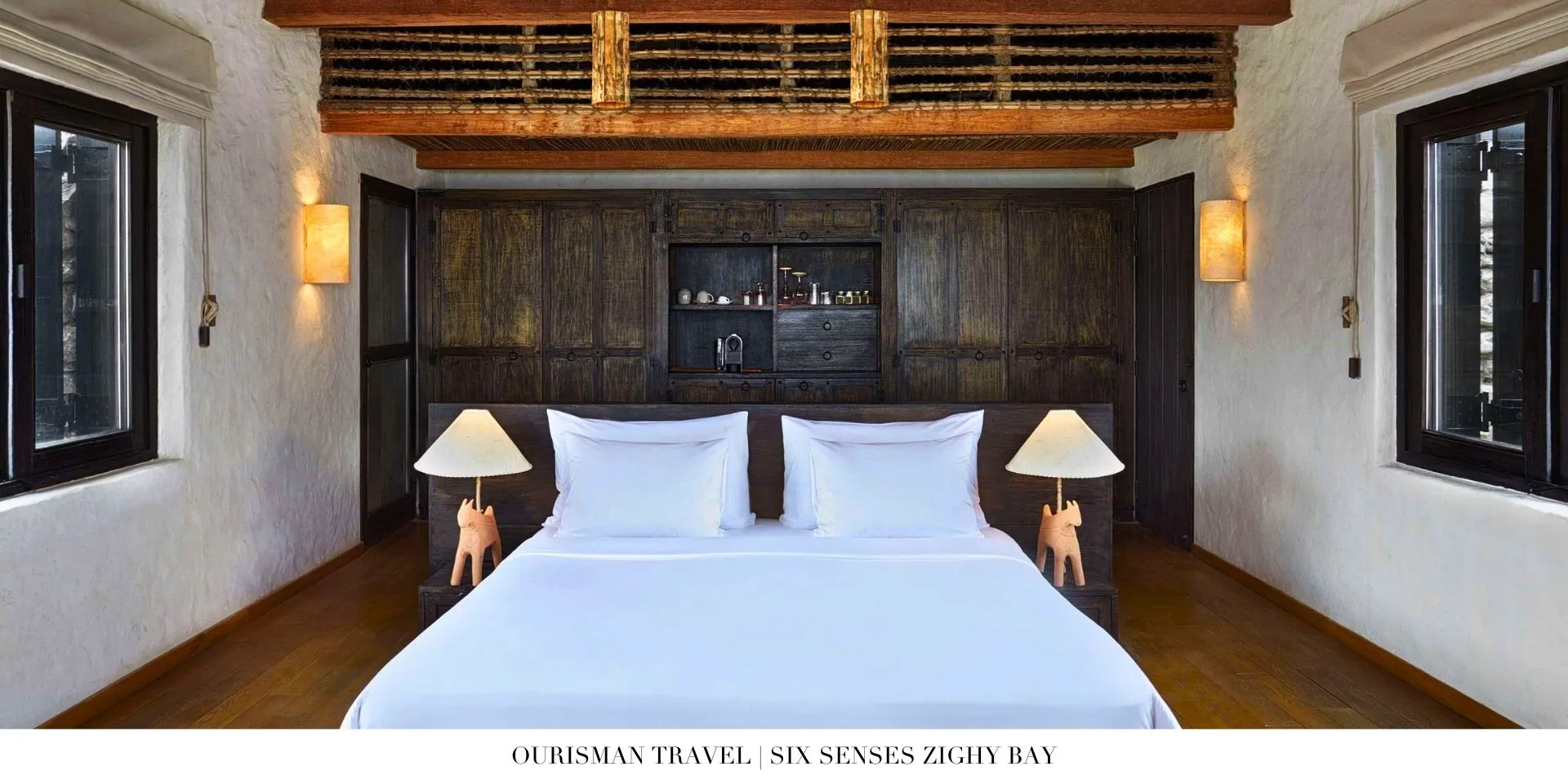 Serene bedroom at Six Senses Zighy Bay with natural materials, vaulted ceilings, and ocean views