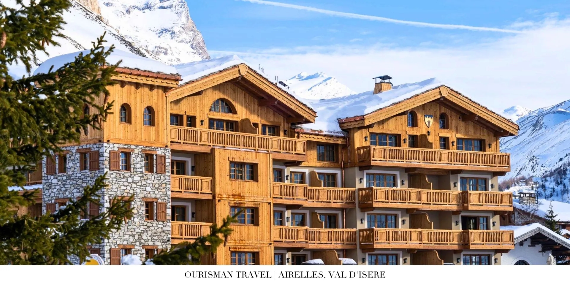 Exterior view of Airelles, Val d’Isère surrounded by snow-capped Alps and ski slopes