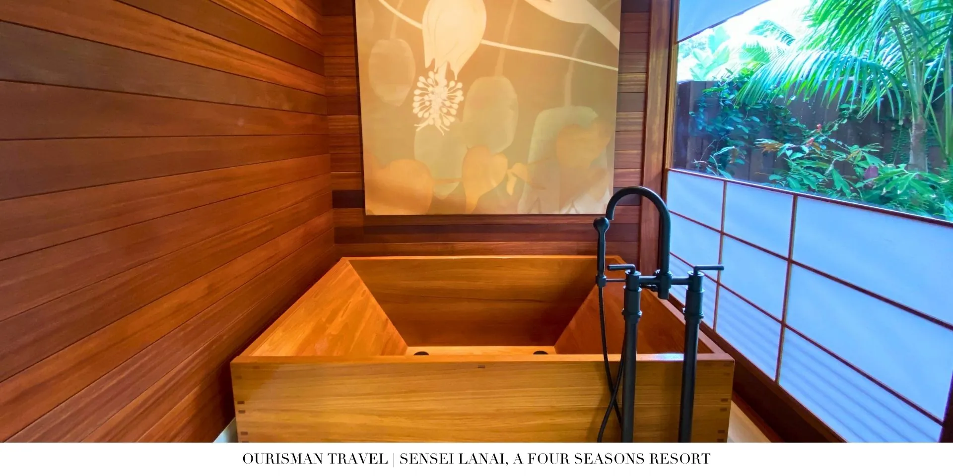 Spa-style bathroom at Sensei Lānaʻi with deep soaking tub, stone finishes, and natural light