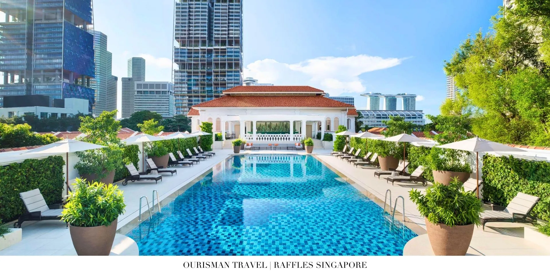 Poolside oasis at Raffles Singapore with lounge chairs and tropical greenery
