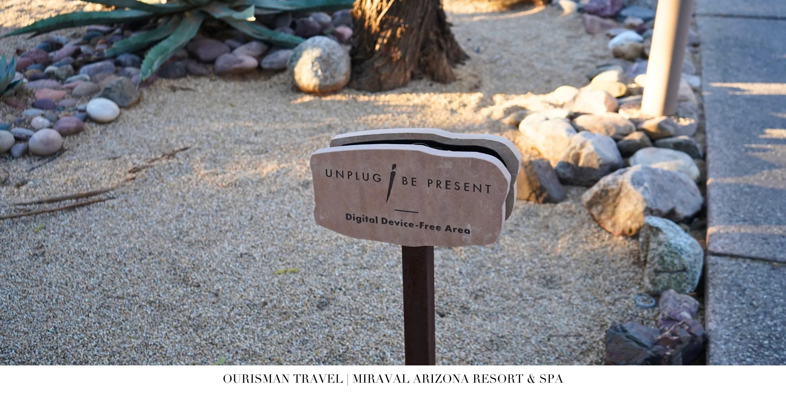 Stone sign reading “Unplug to Be Present” at Miraval Arizona Resort