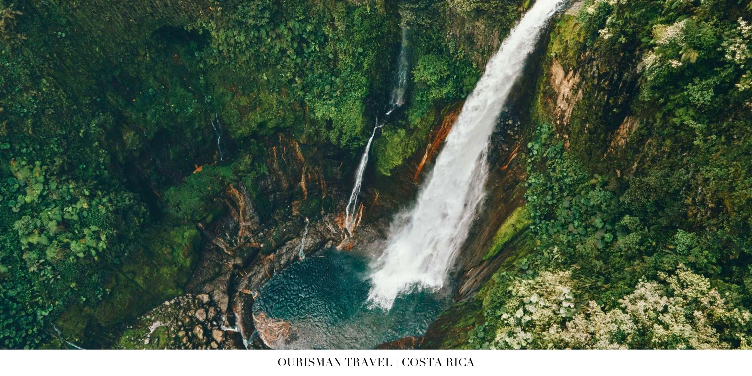 Majestic waterfall cascading into a lush jungle pool in Costa Rica