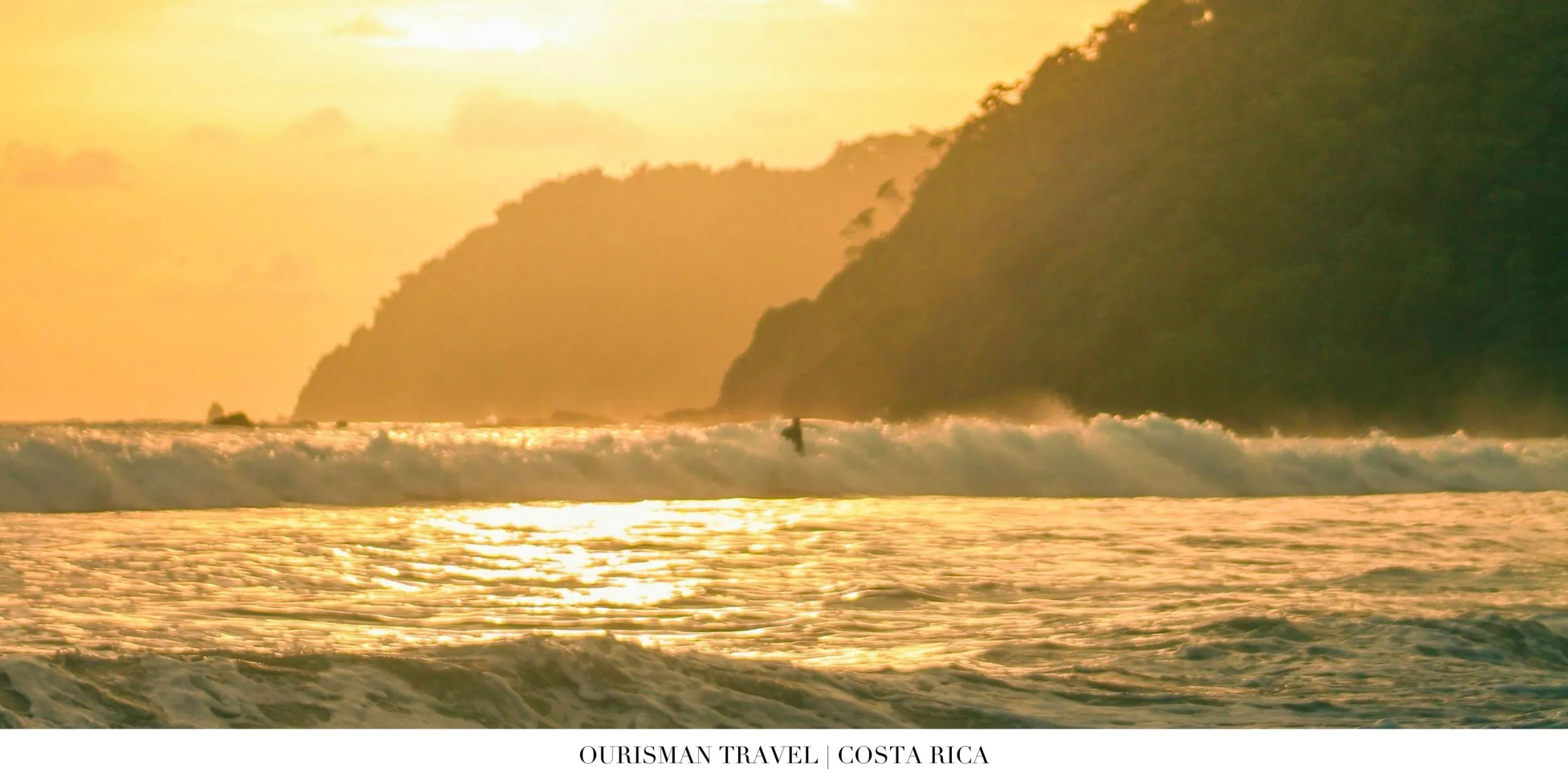 Surfer riding a turquoise wave on Costa Rica’s Pacific coast