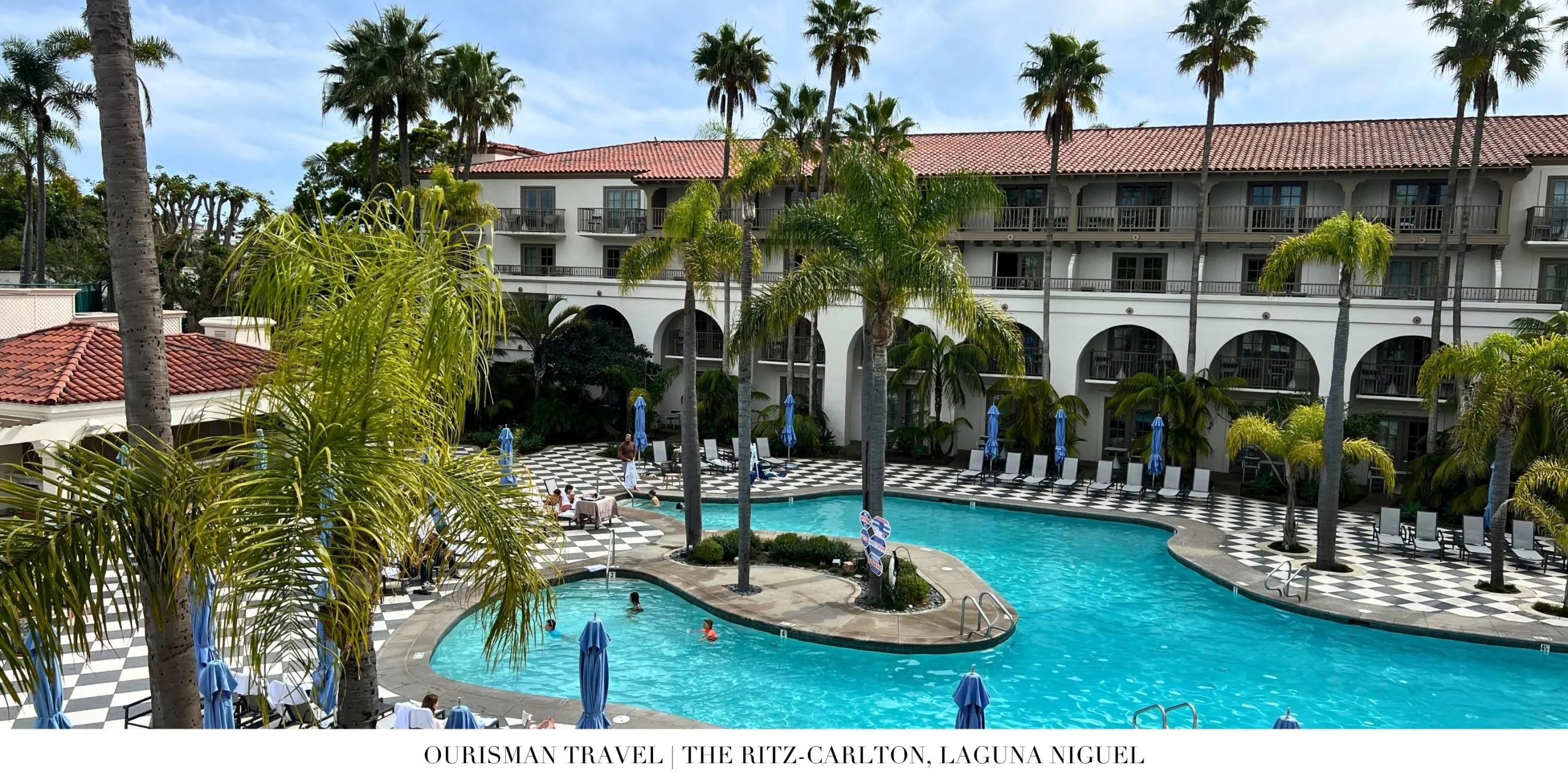 Resort pool area at The Ritz-Carlton, Laguna Niguel with palm-lined surroundings