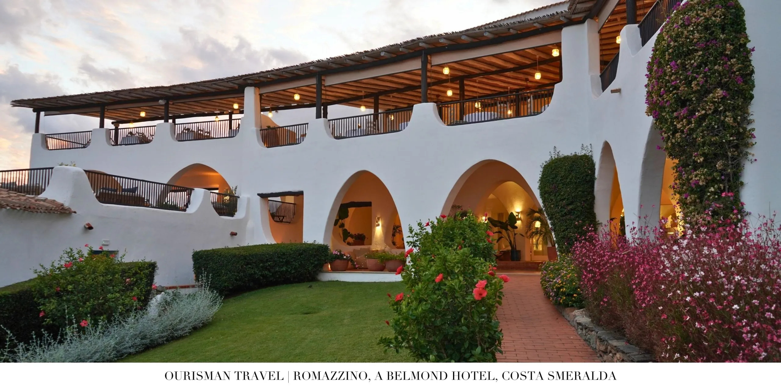 Exterior view of Romazzino, A Belmond Hotel with whitewashed Mediterranean architecture